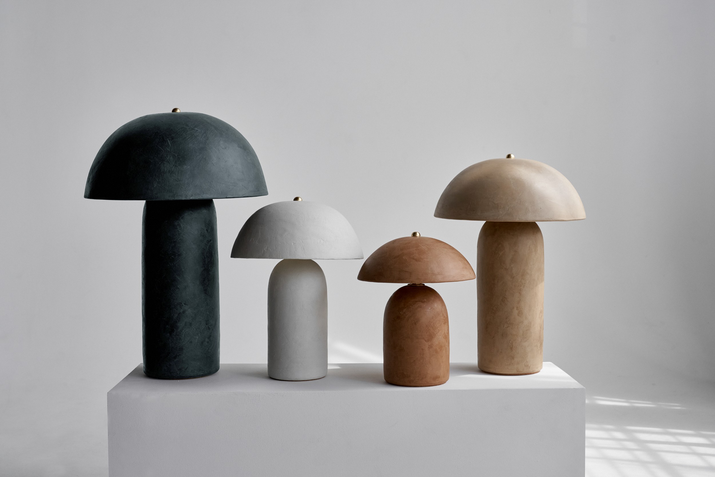 a group of different colored mushrooms sitting on top of a white surface