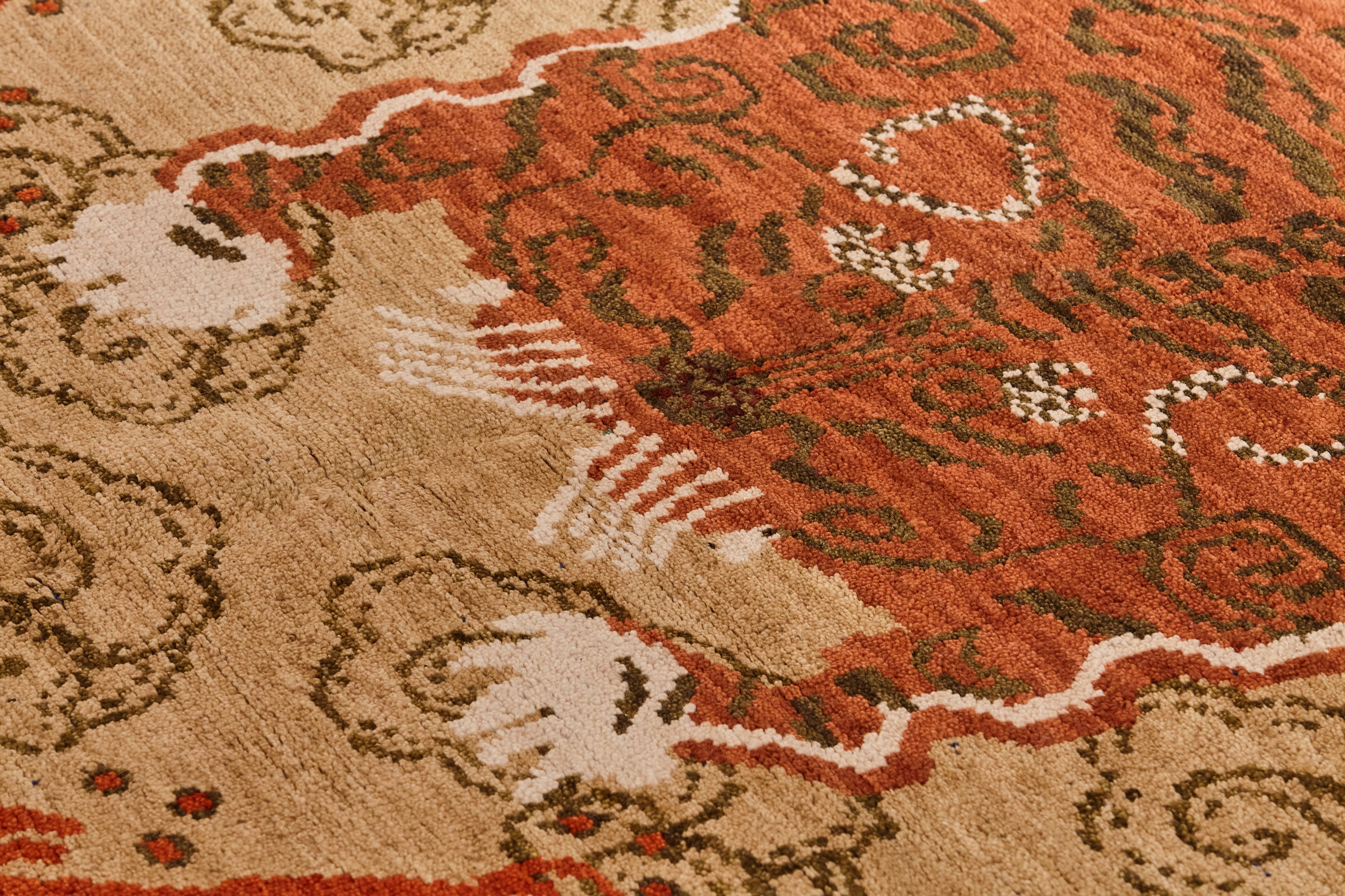 a close up of a red and beige rug