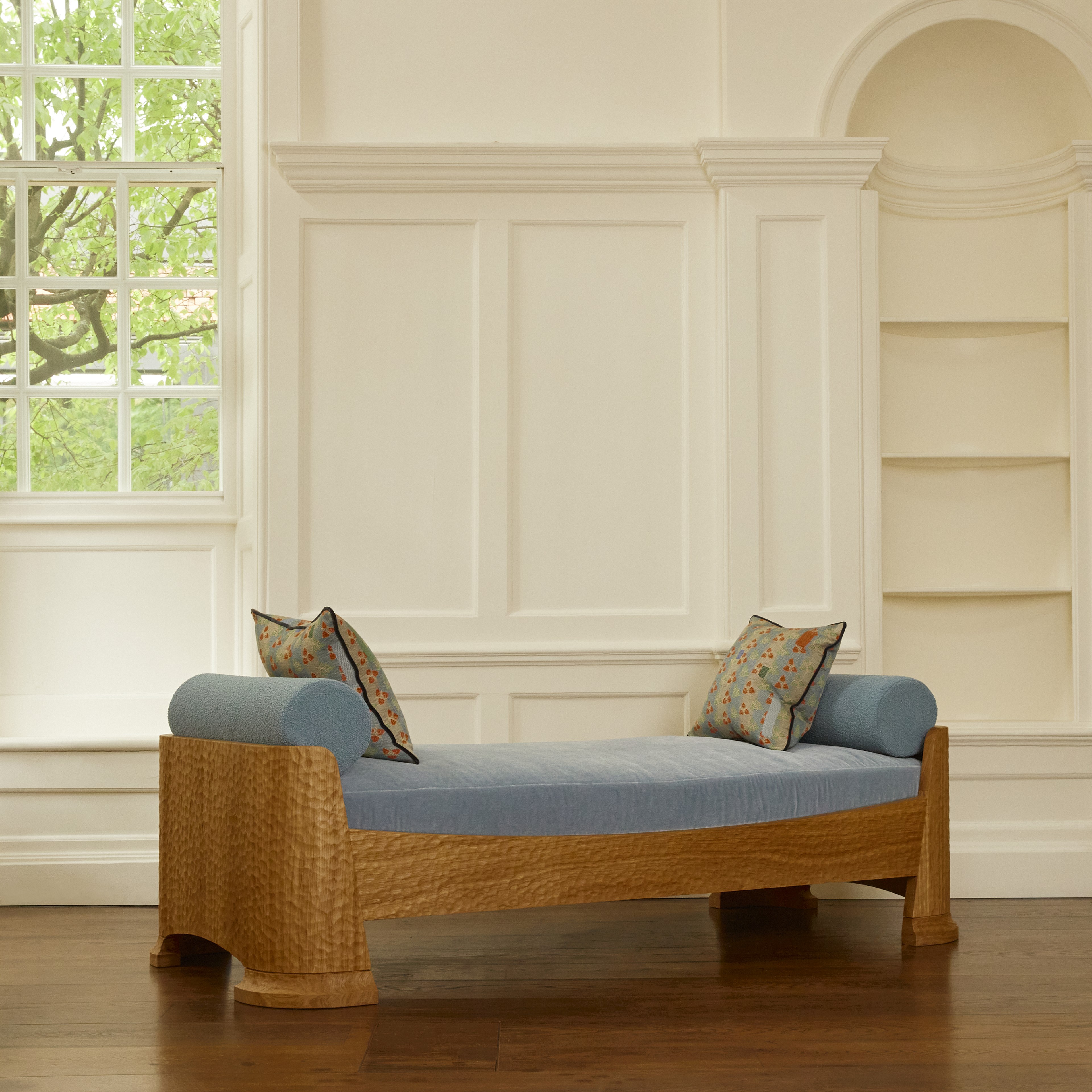 a wooden bench with a blue cushion on it