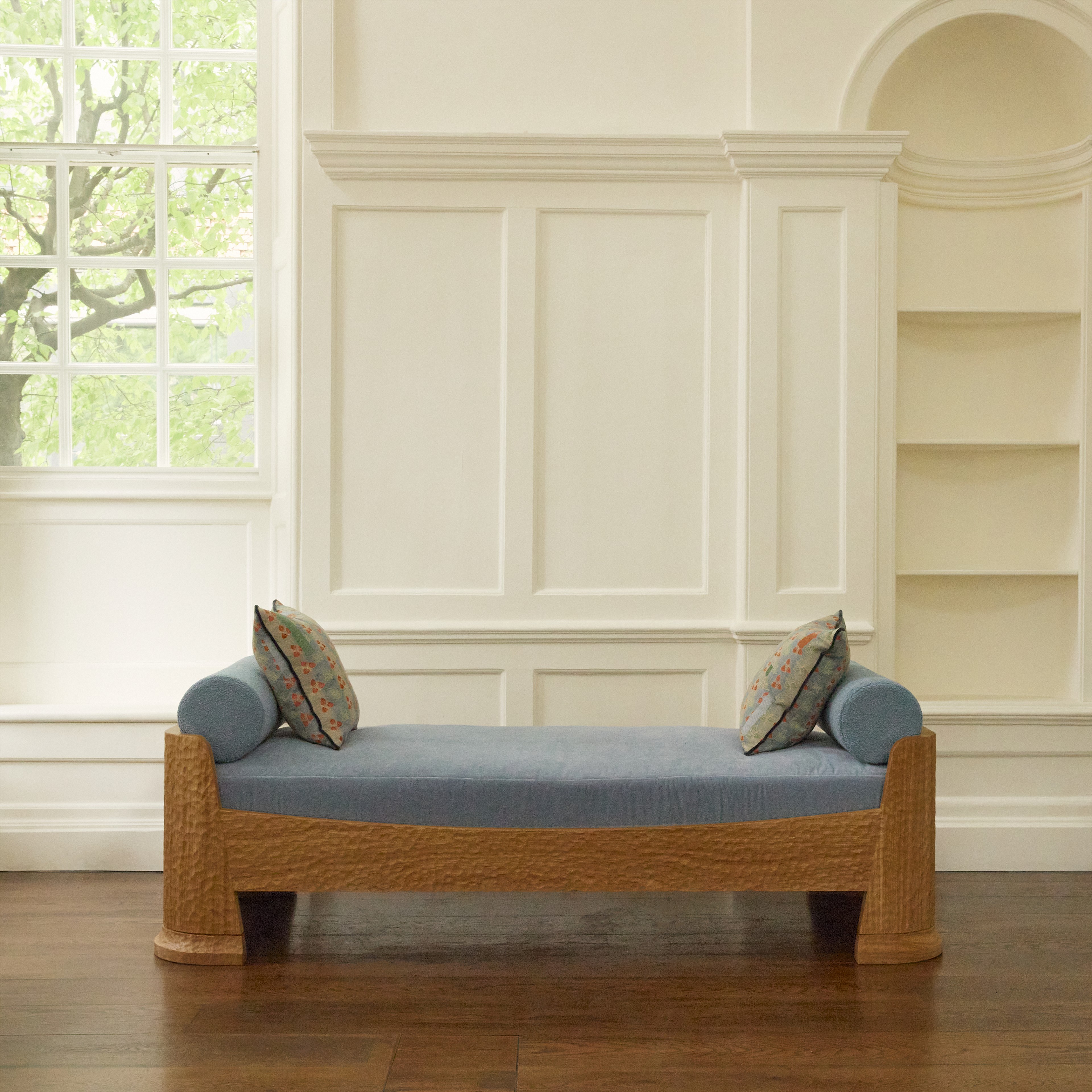 a blue couch sitting on top of a hard wood floor