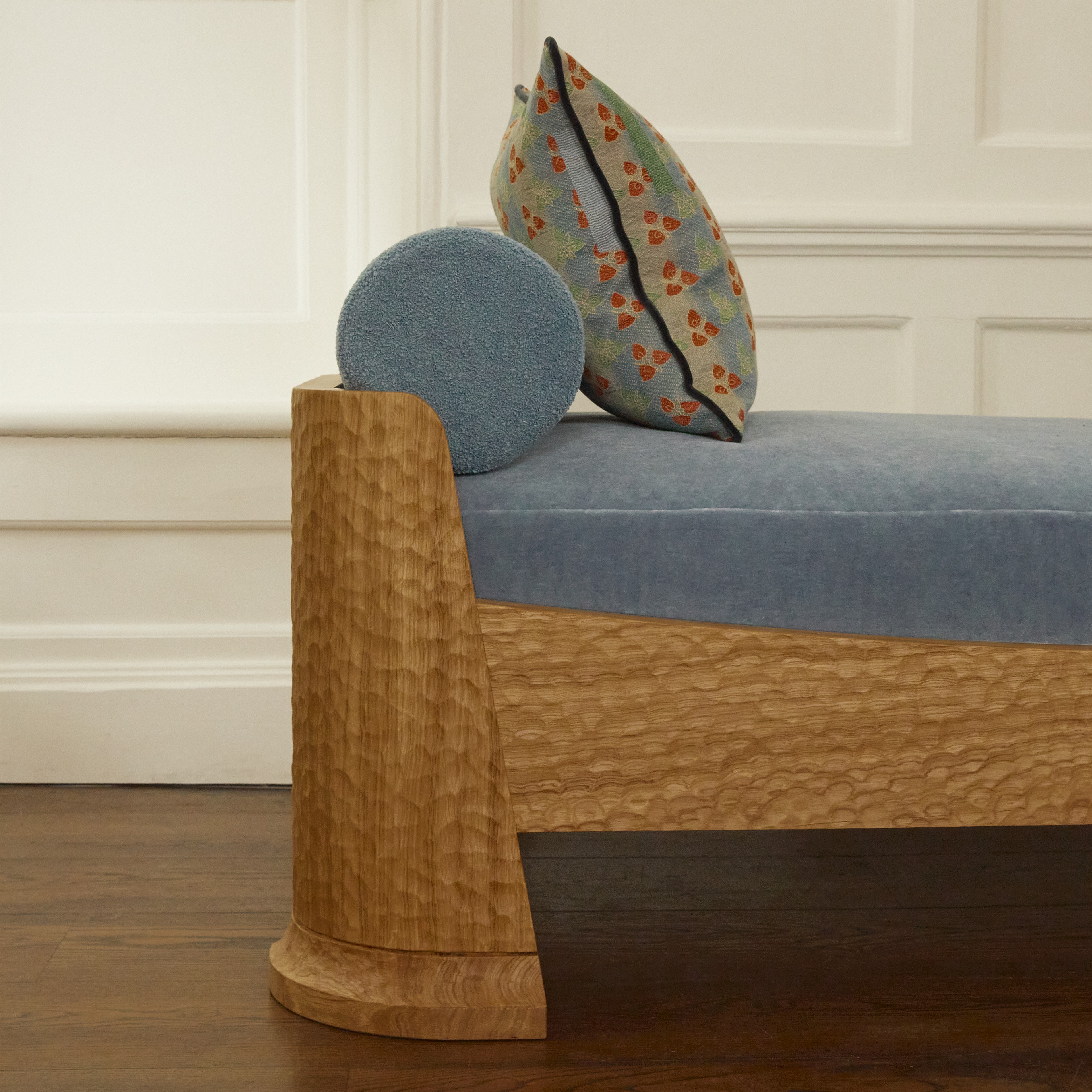 a wooden bench with a cushion on top of it