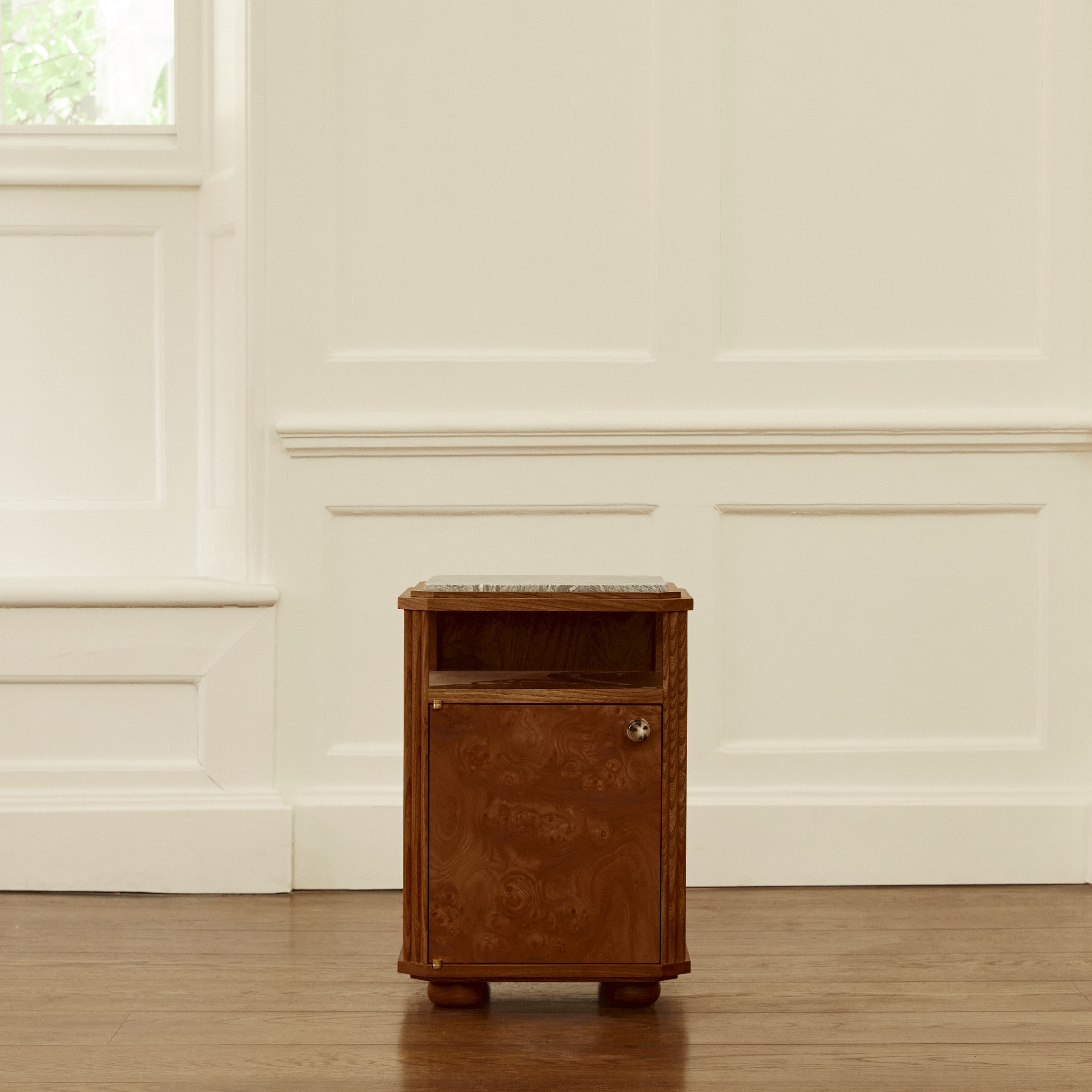 a small wooden cabinet sitting on top of a hard wood floor