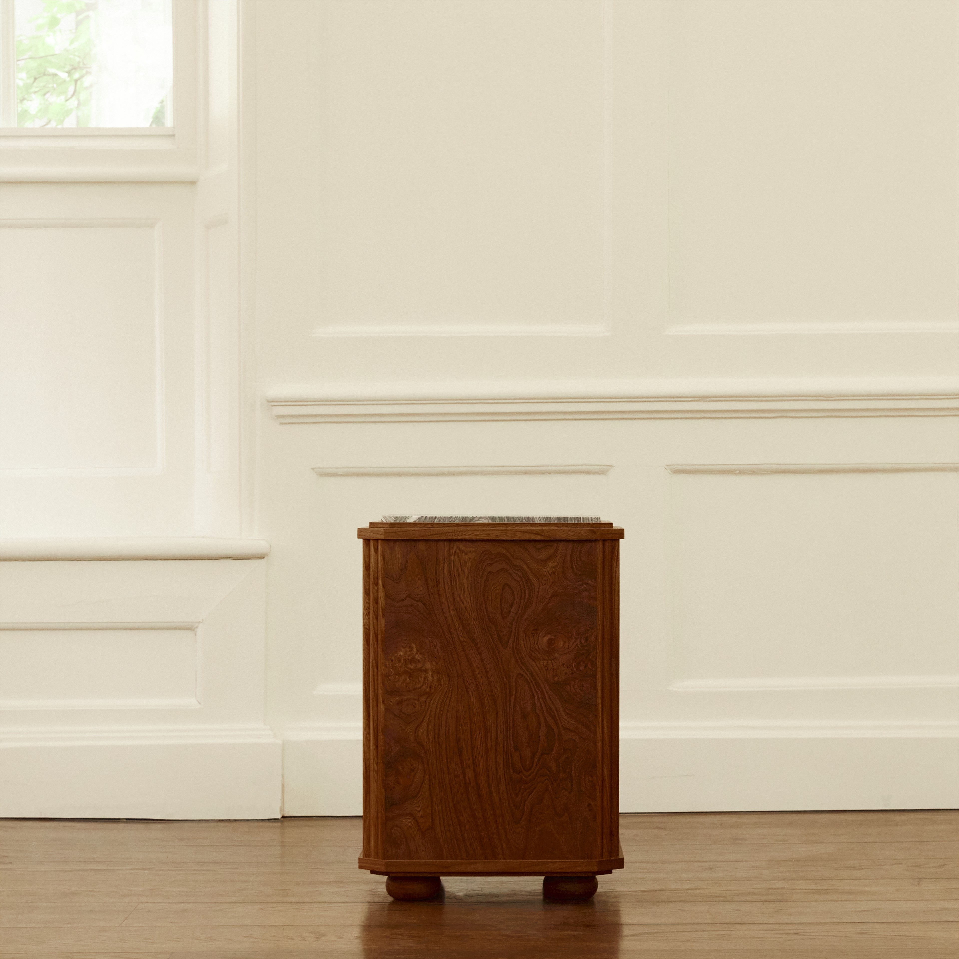 a wooden trash can sitting on top of a hard wood floor