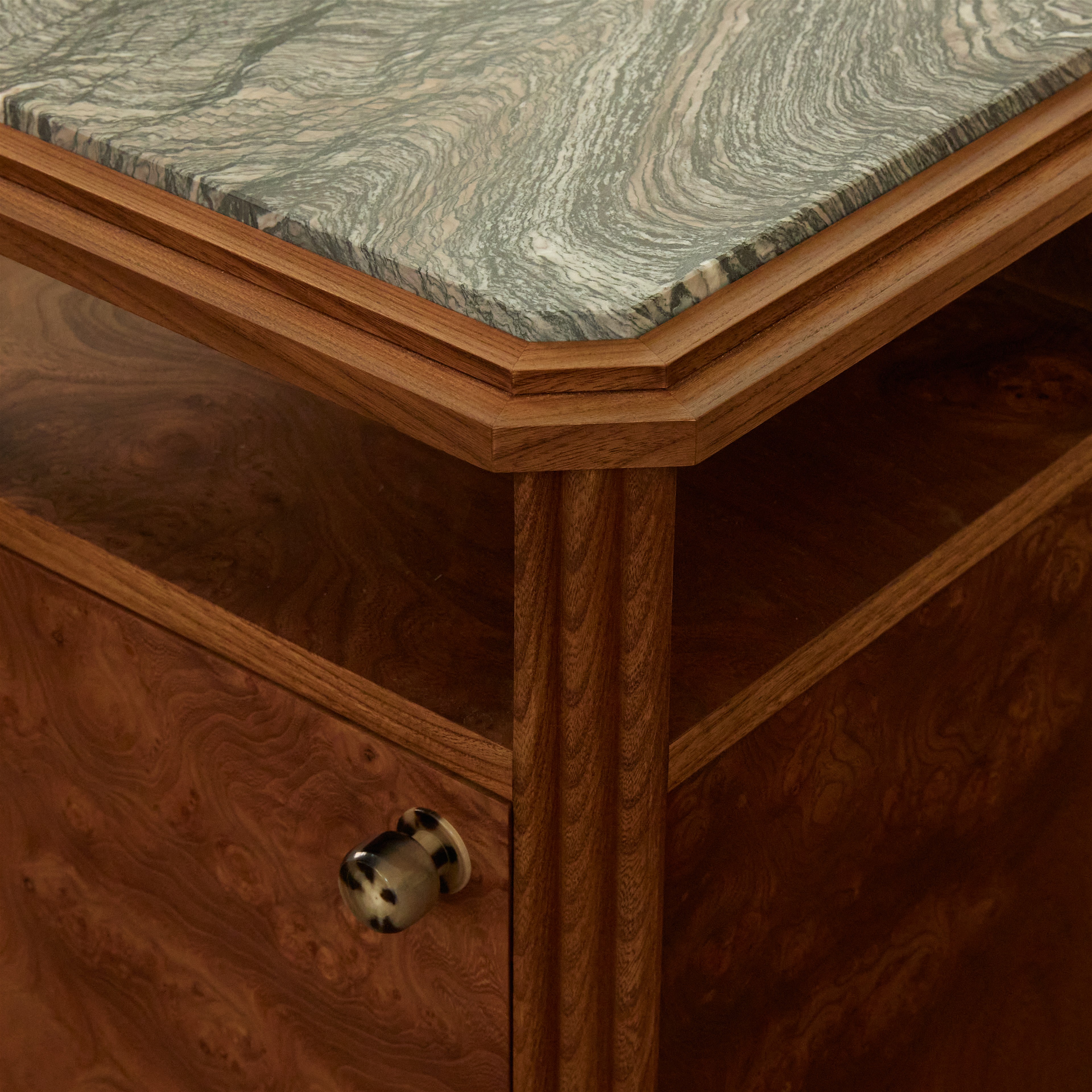 a close up of a wooden table with a marble top
