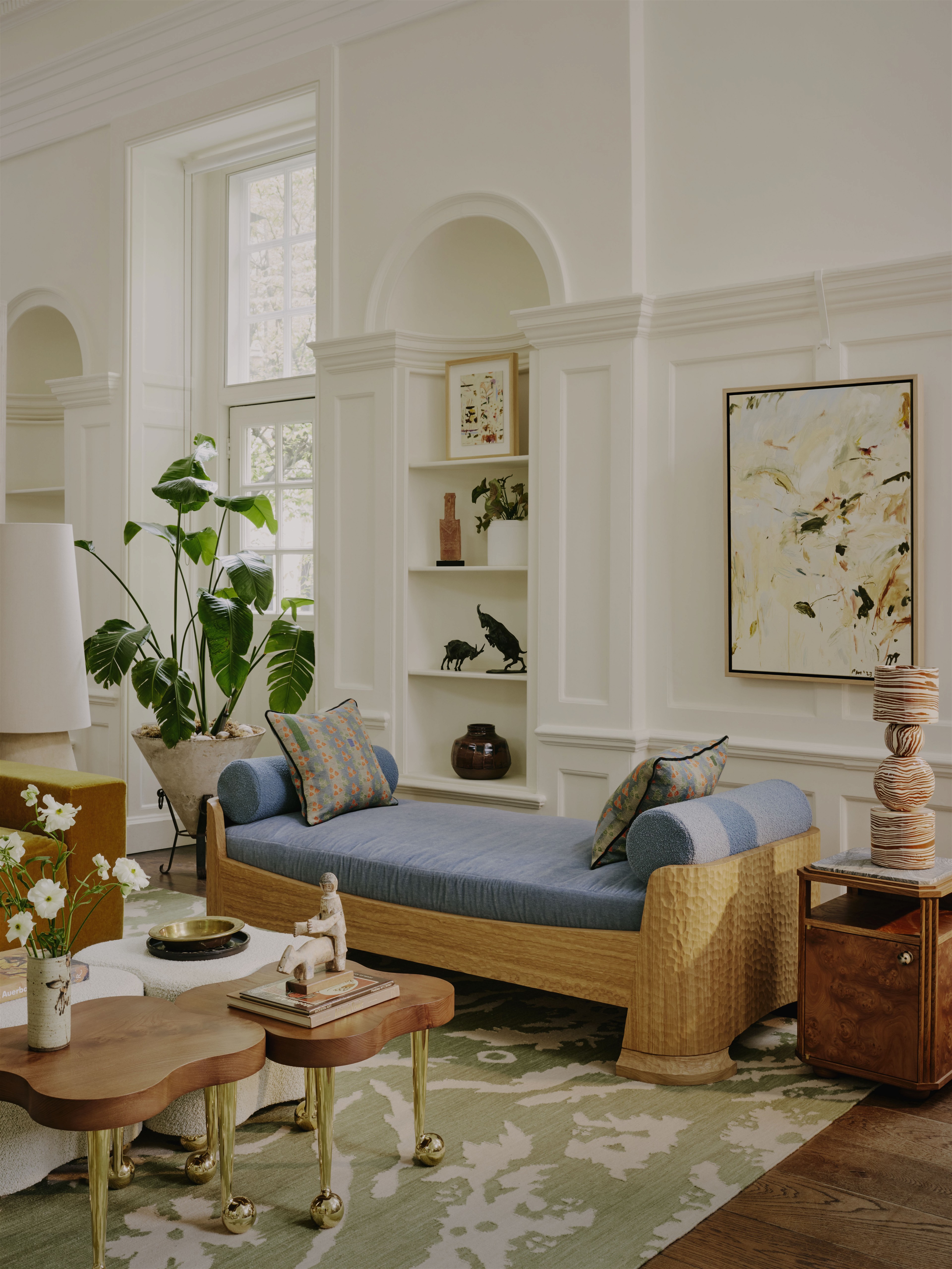 a living room filled with furniture and a potted plant