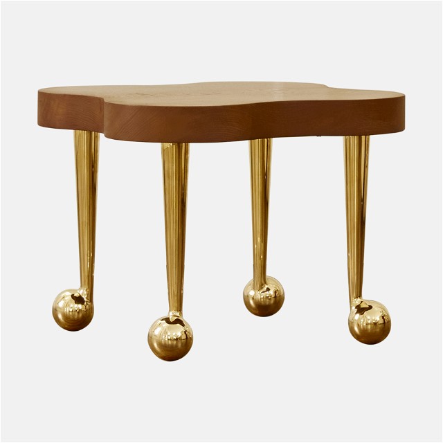 a table with three legs and three balls on it