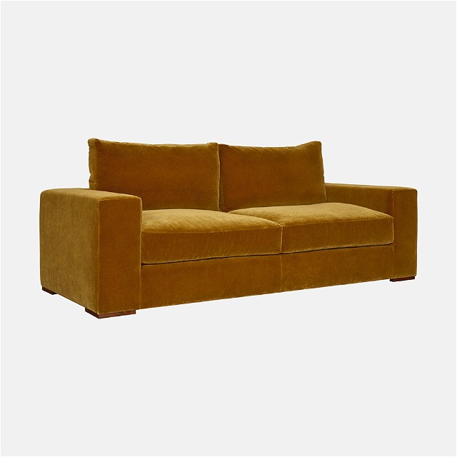 a brown couch sitting on top of a white floor