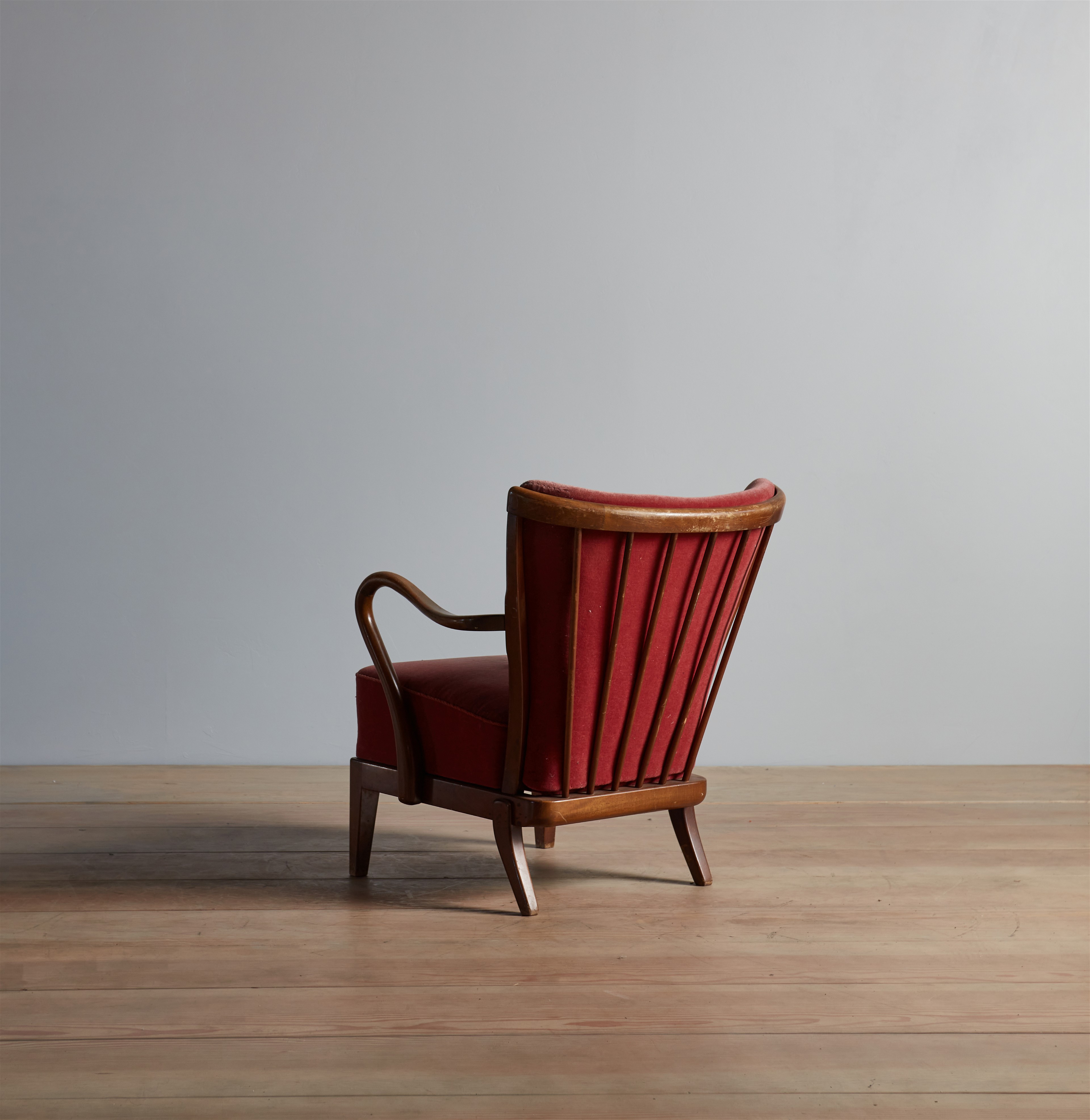 a red chair sitting on top of a wooden floor
