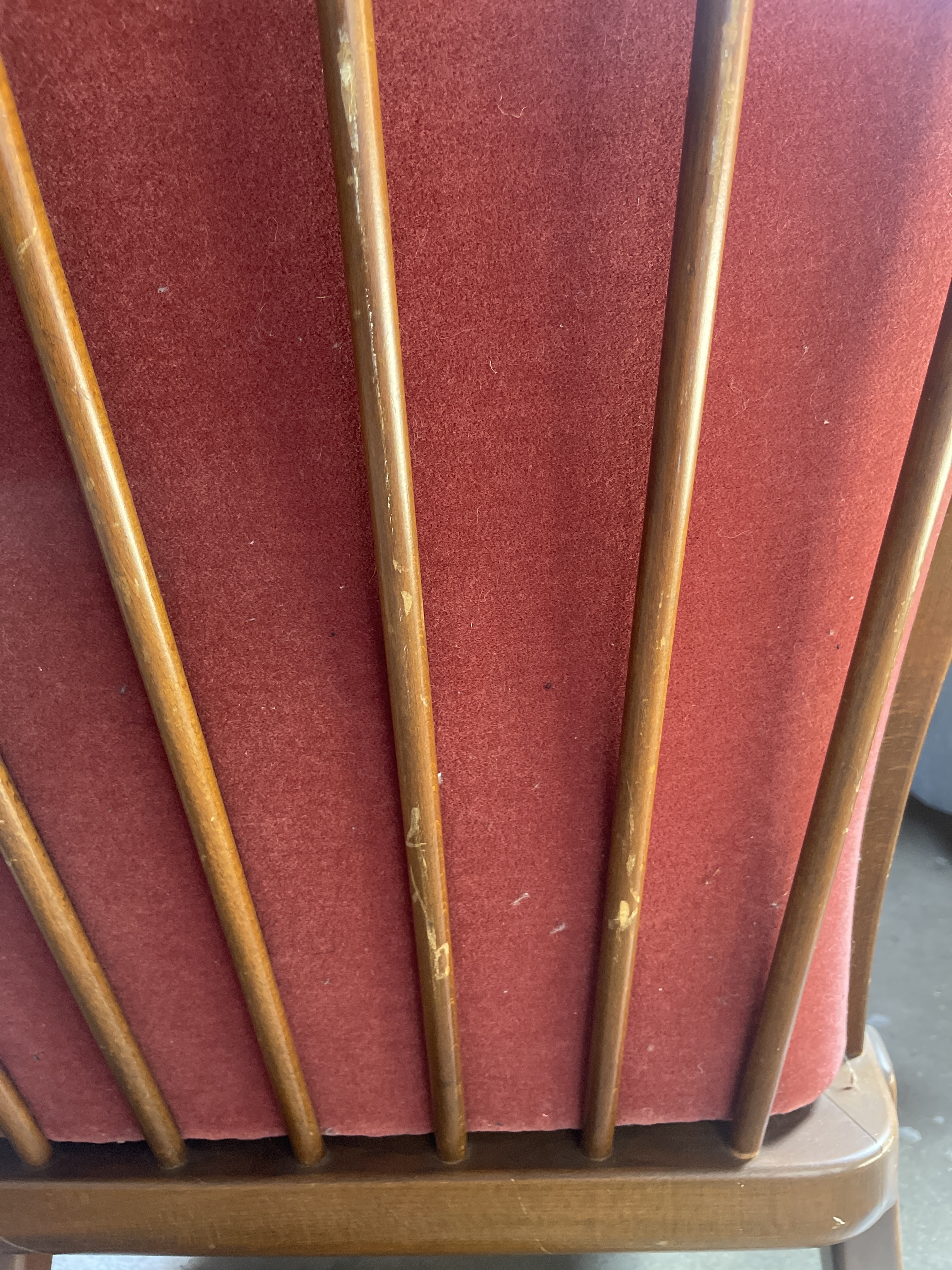 a close up of a chair with wooden sticks sticking out of it