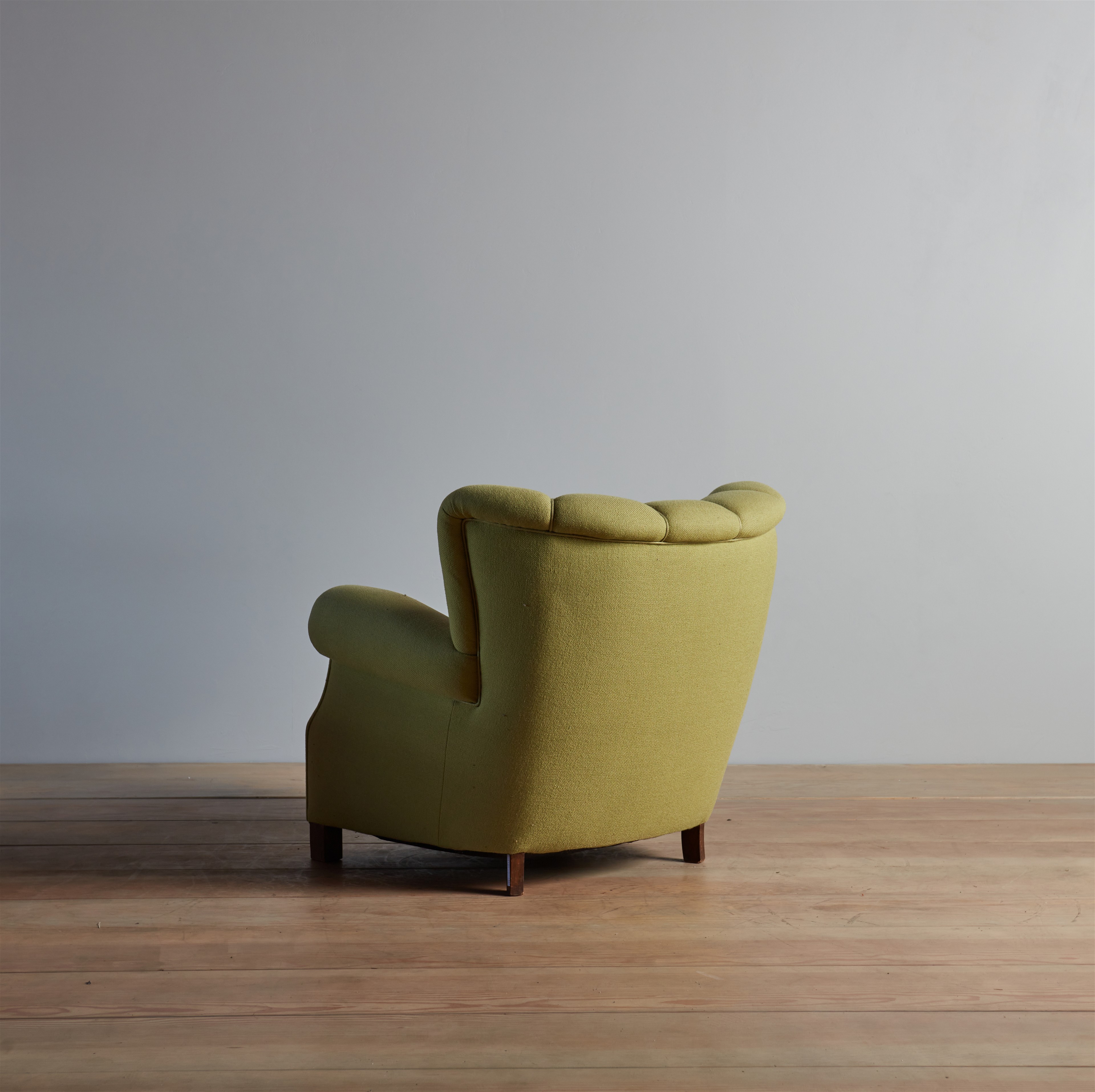 a yellow chair sitting on top of a wooden floor