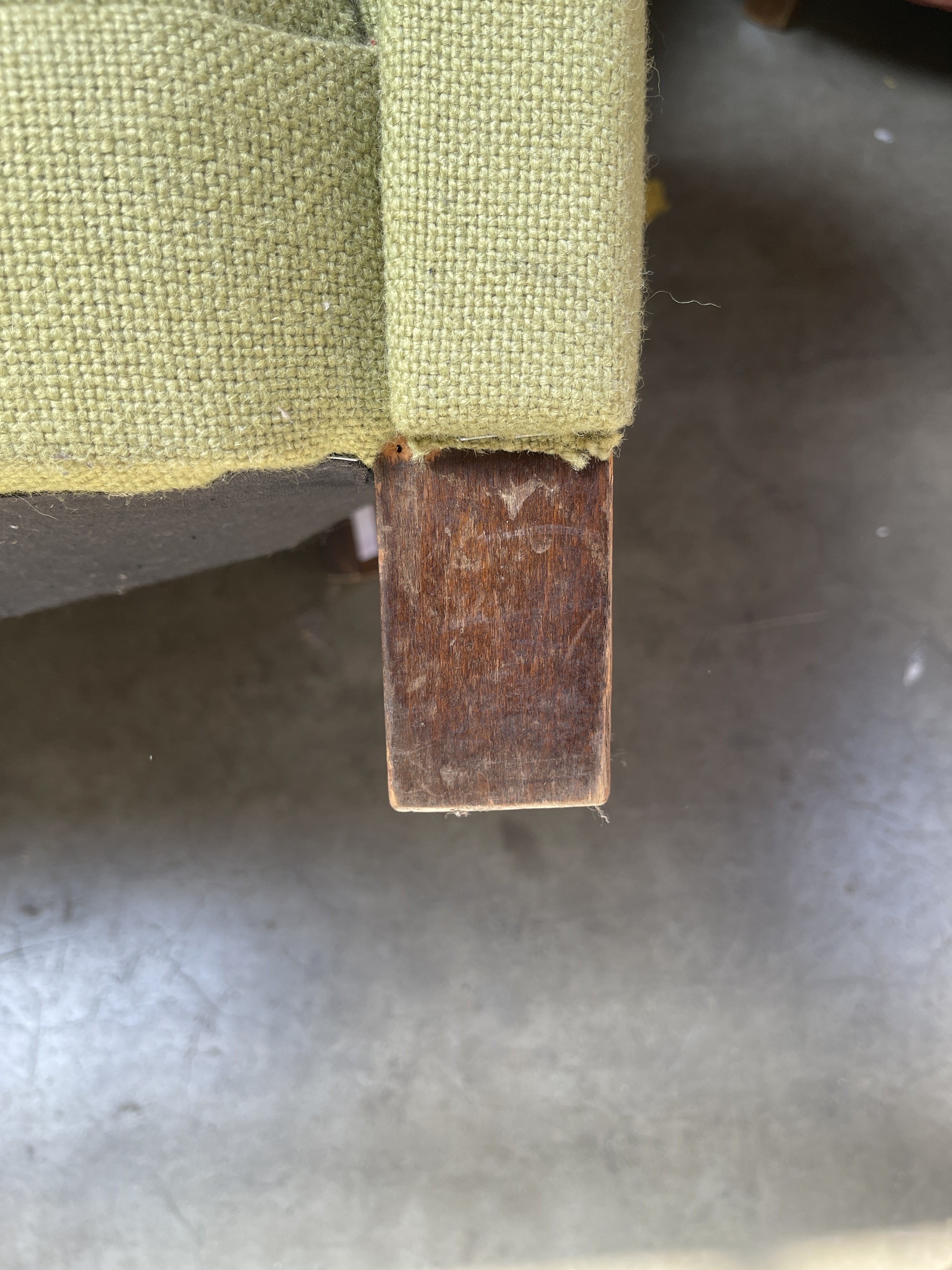 a piece of wood sticking out of the side of a couch