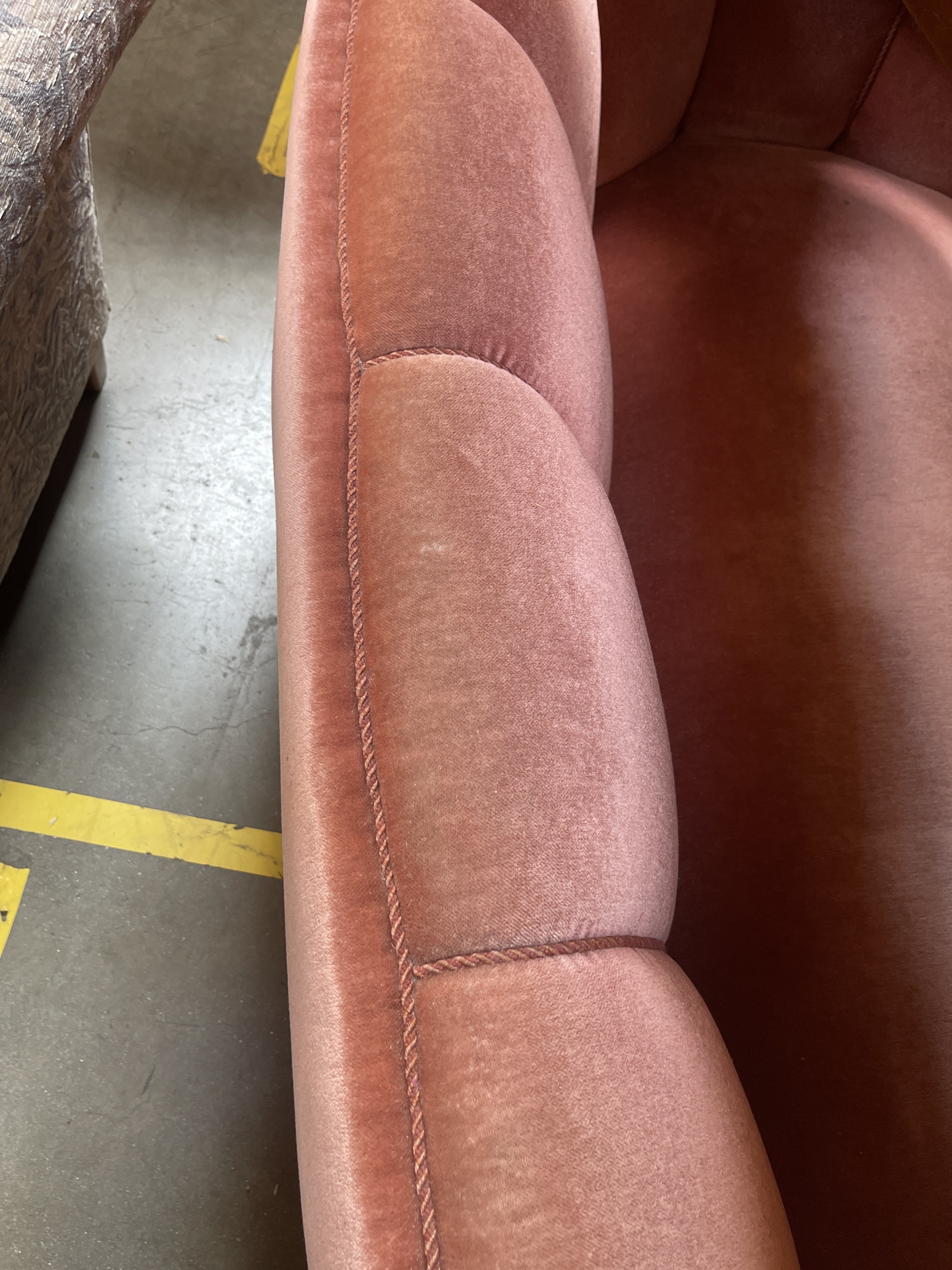 a close up of a pink couch on a floor