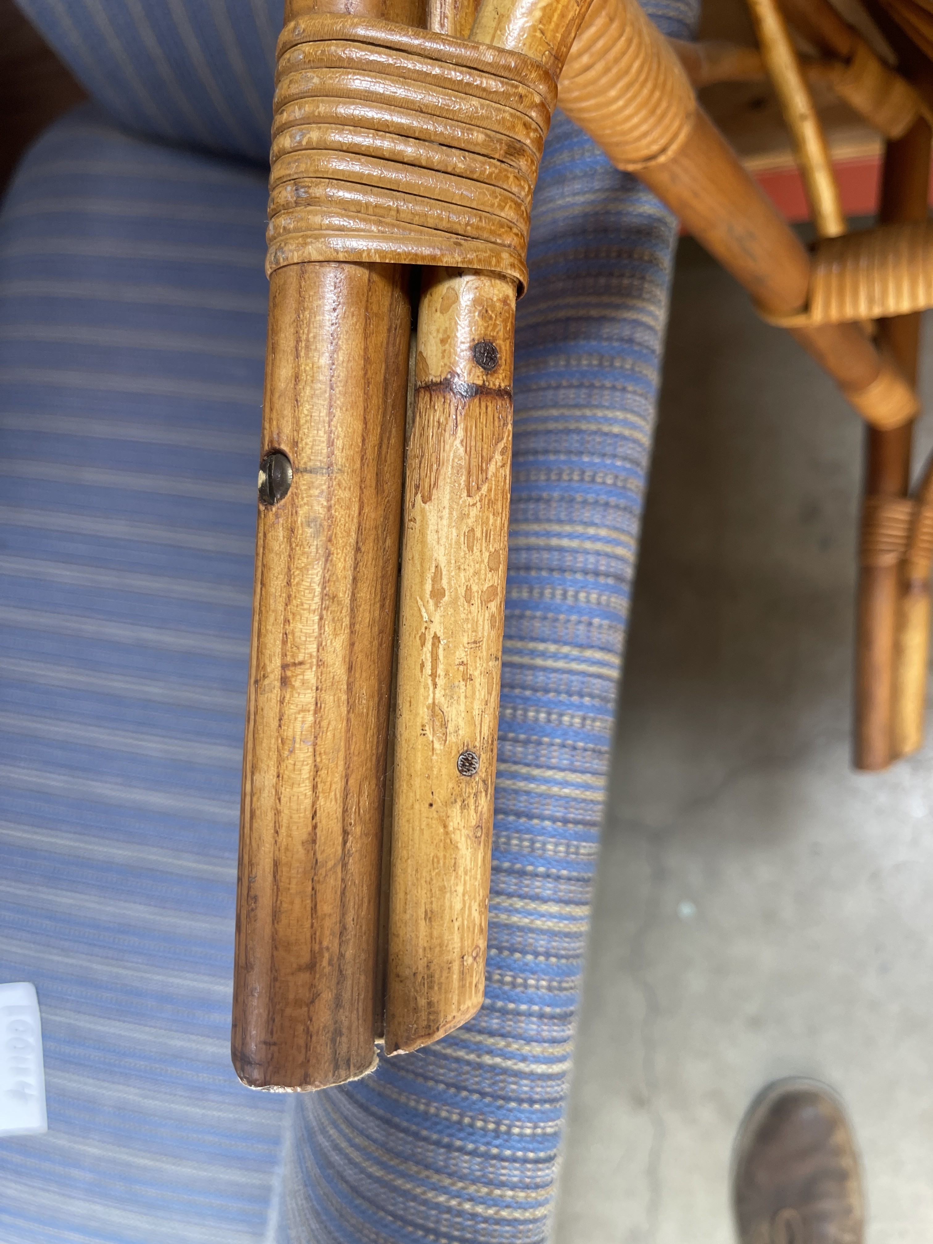 a close up of a chair with a wooden handle