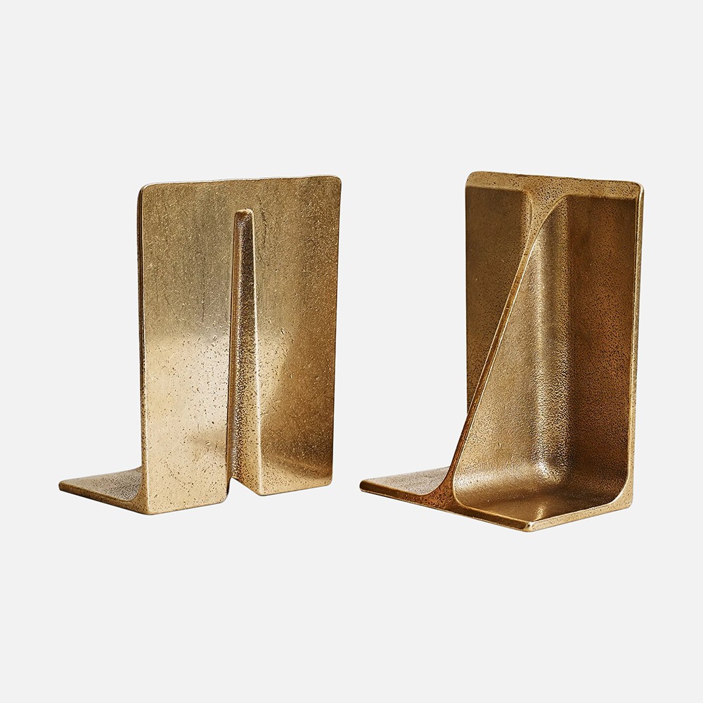 a pair of gold bookends on a white background