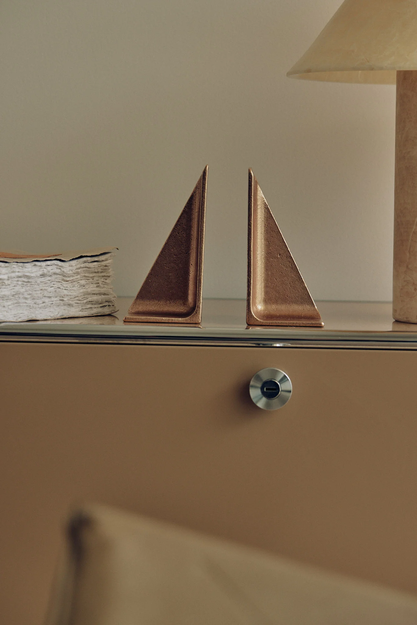 a pair of sail boats on top of a dresser