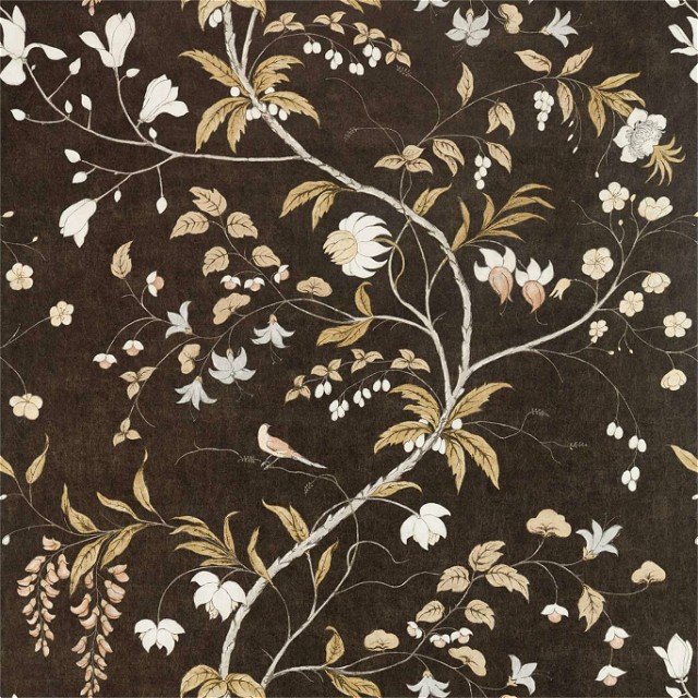 a brown rug with white flowers and leaves on it