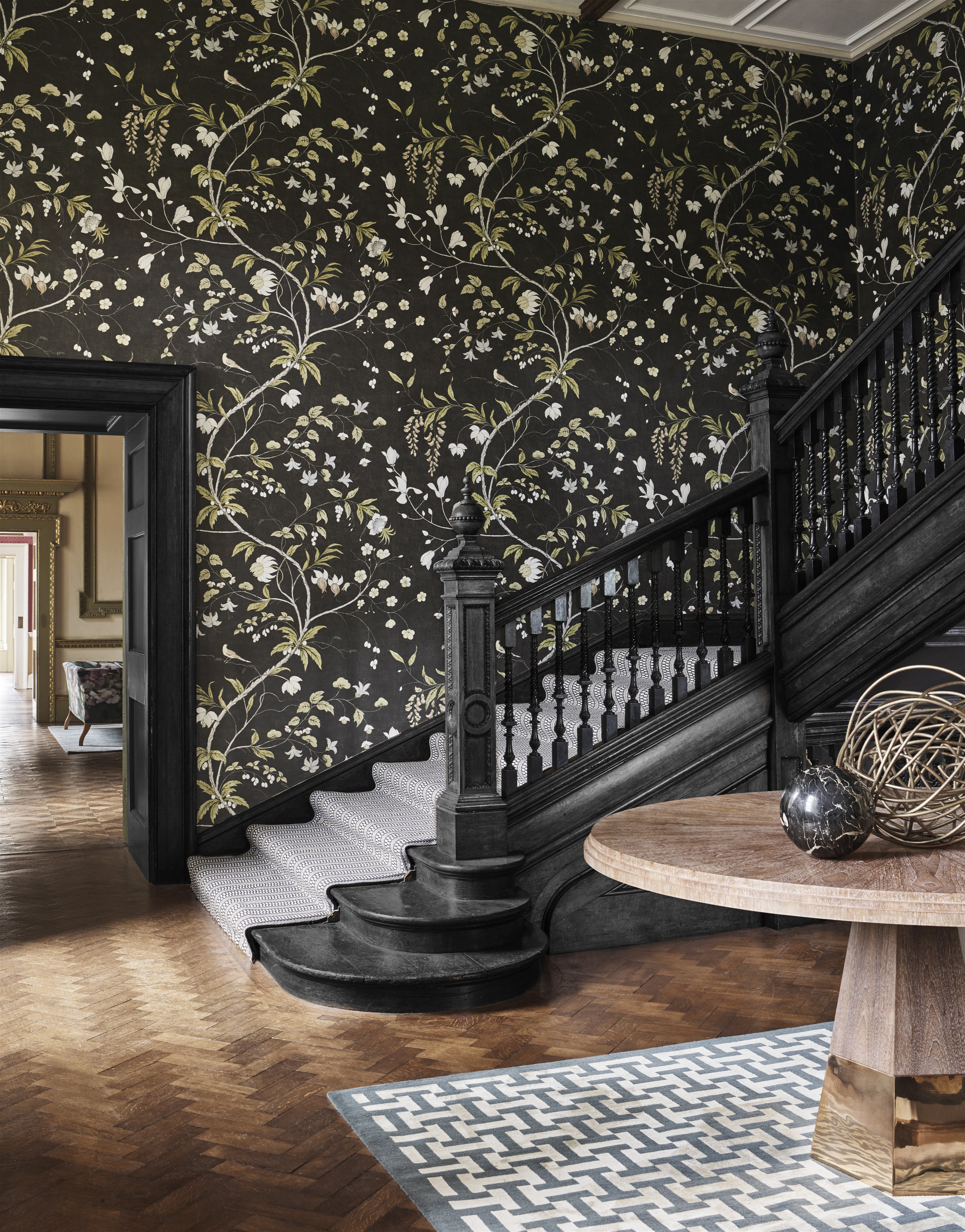 a staircase in a house with a floral wallpaper