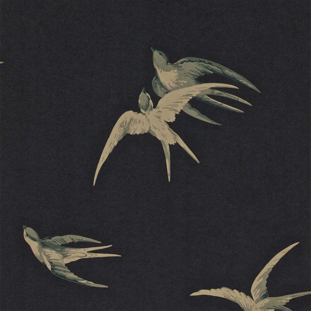 a flock of birds flying through a dark sky