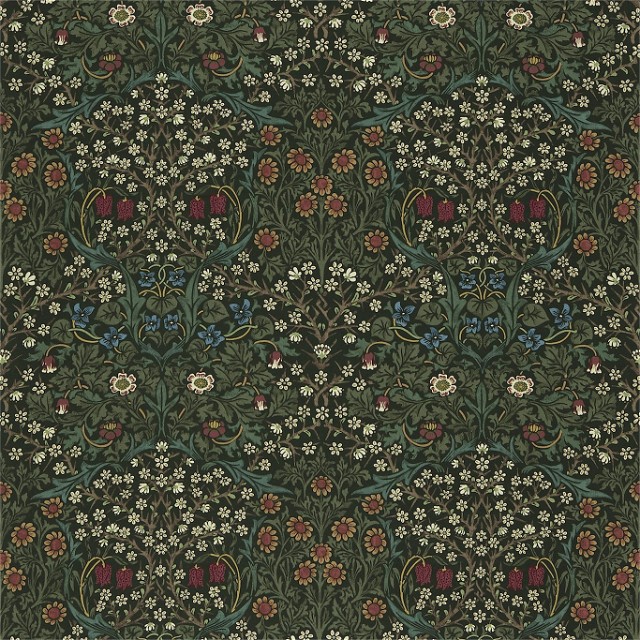 a green and red rug with flowers and leaves