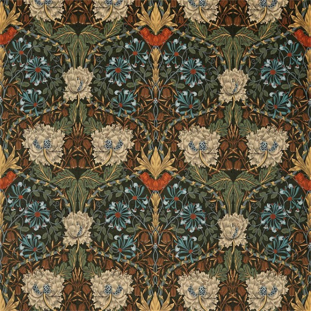a large floral design on a brown background