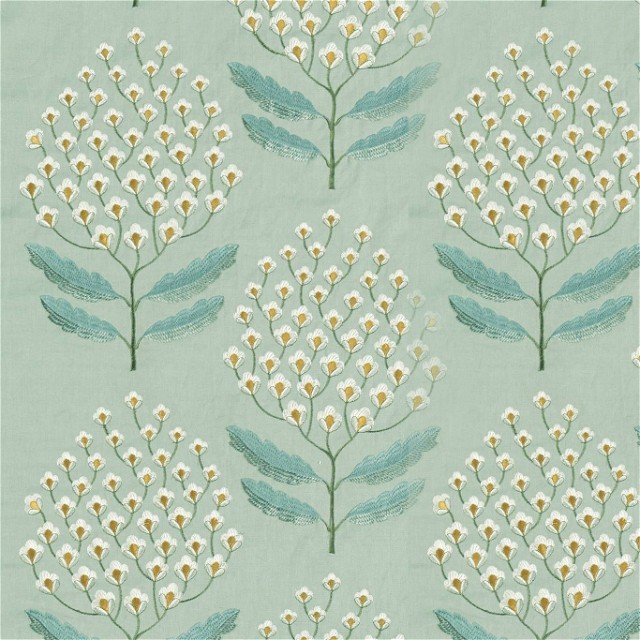 a blue and white flower pattern on a green background