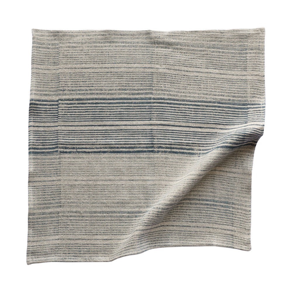 a gray and black striped blanket on a white background