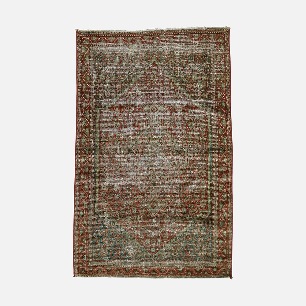 a rug with a red and green design on it