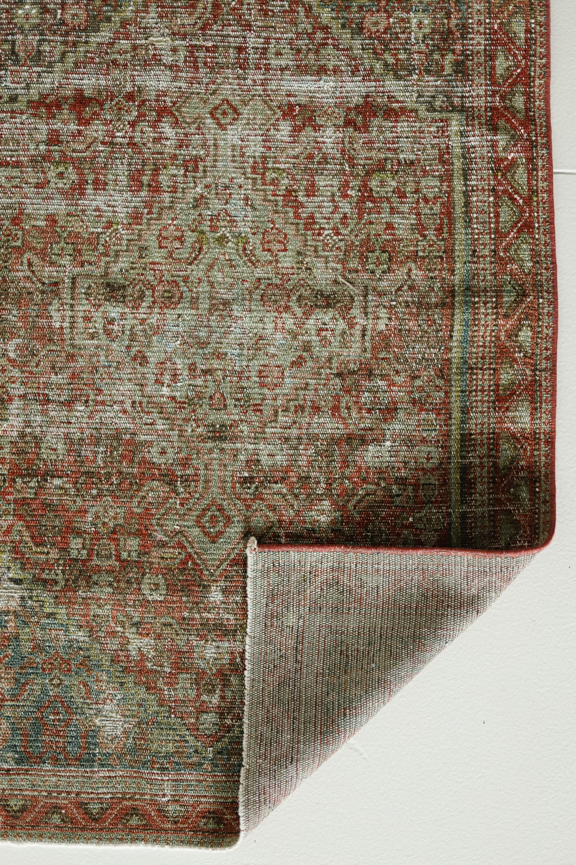 a rug with a red and green design on it