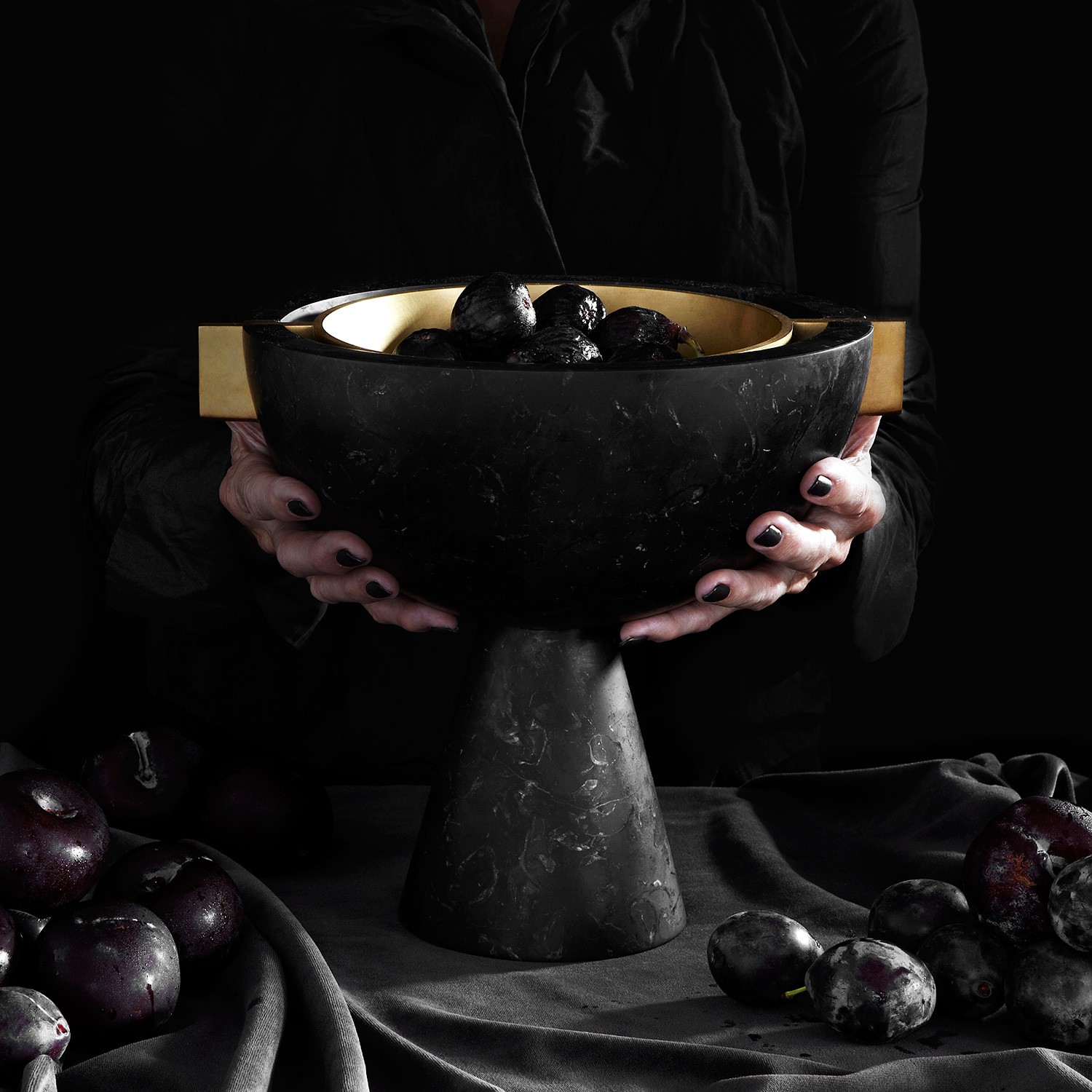 a person holding a bowl of fruit in their hands