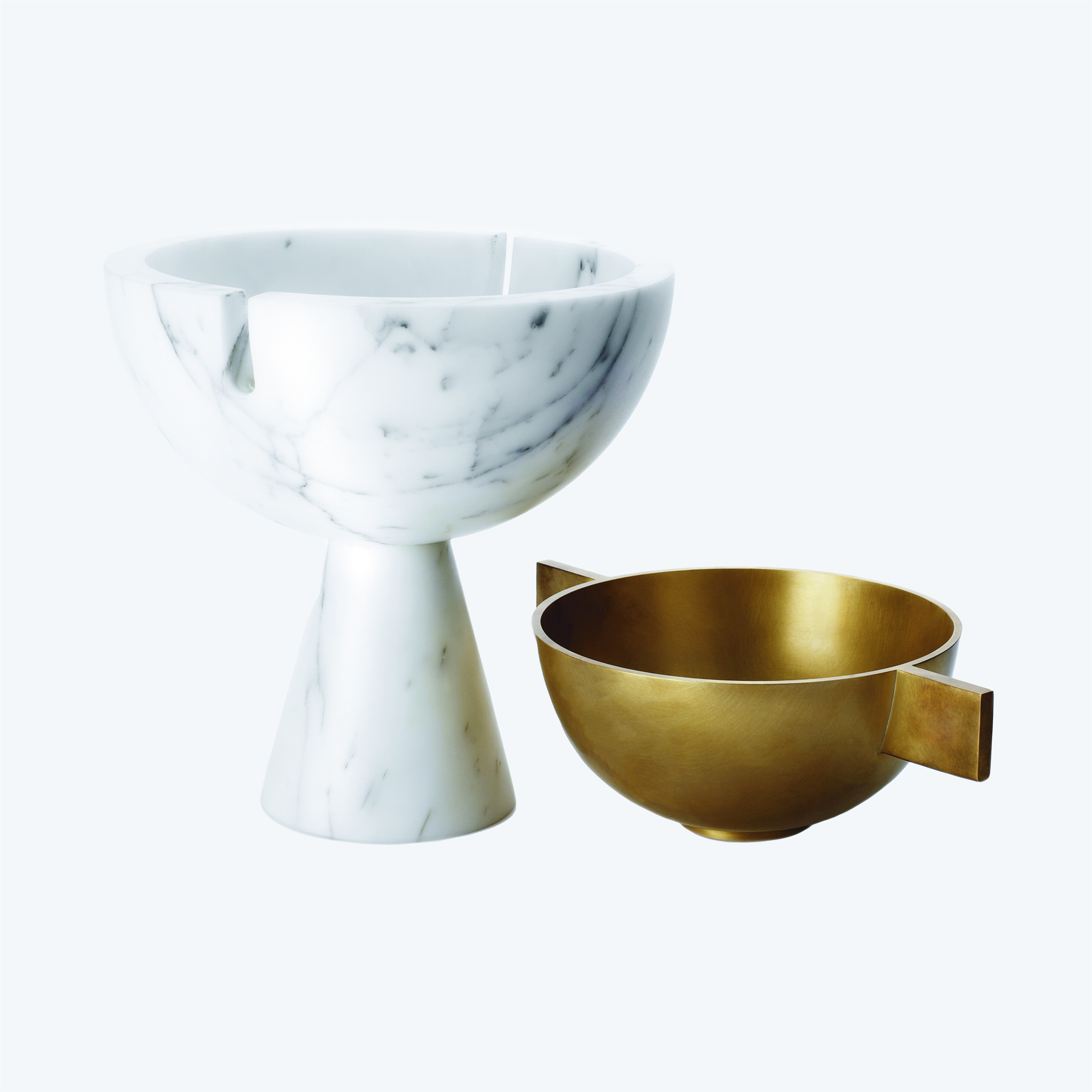 a white marble bowl and a gold metal bowl