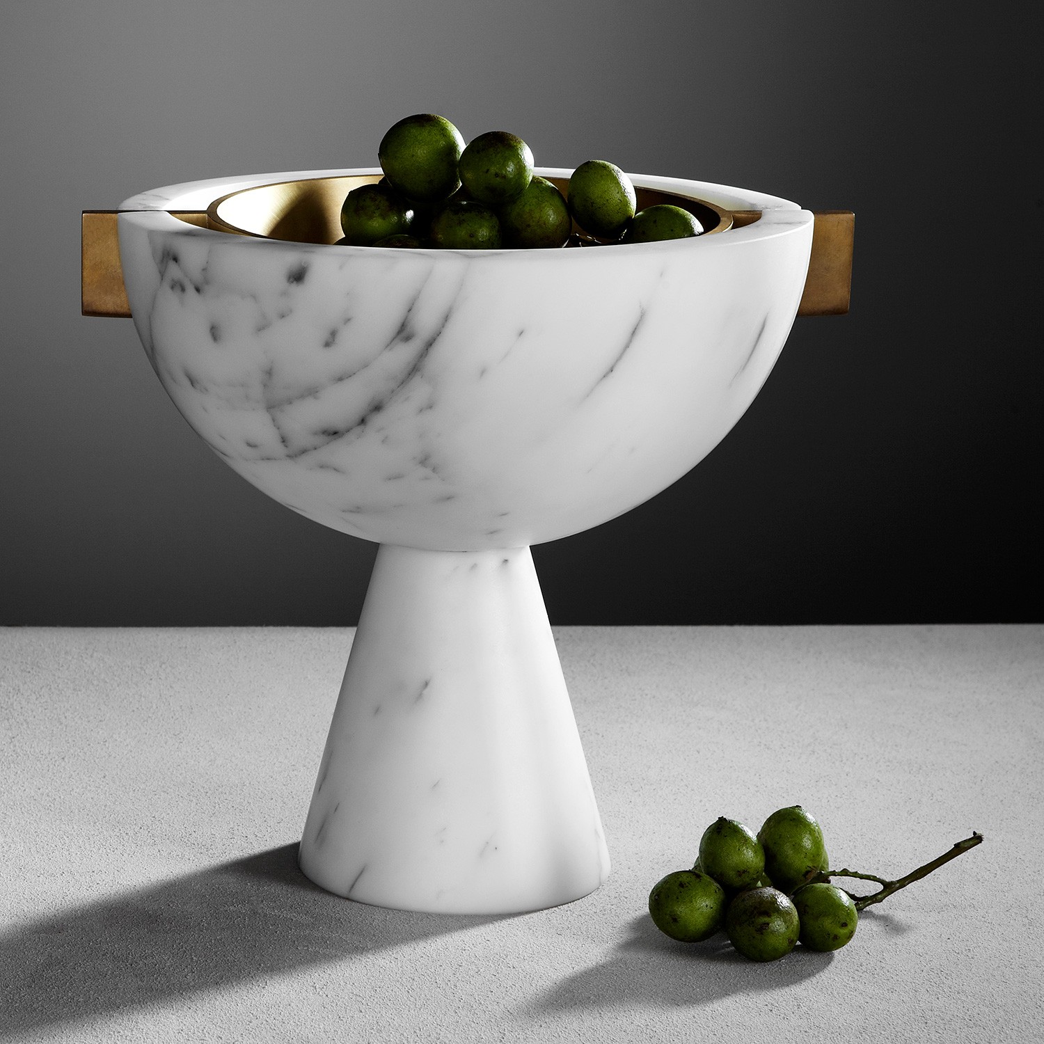 a marble bowl with some olives in it