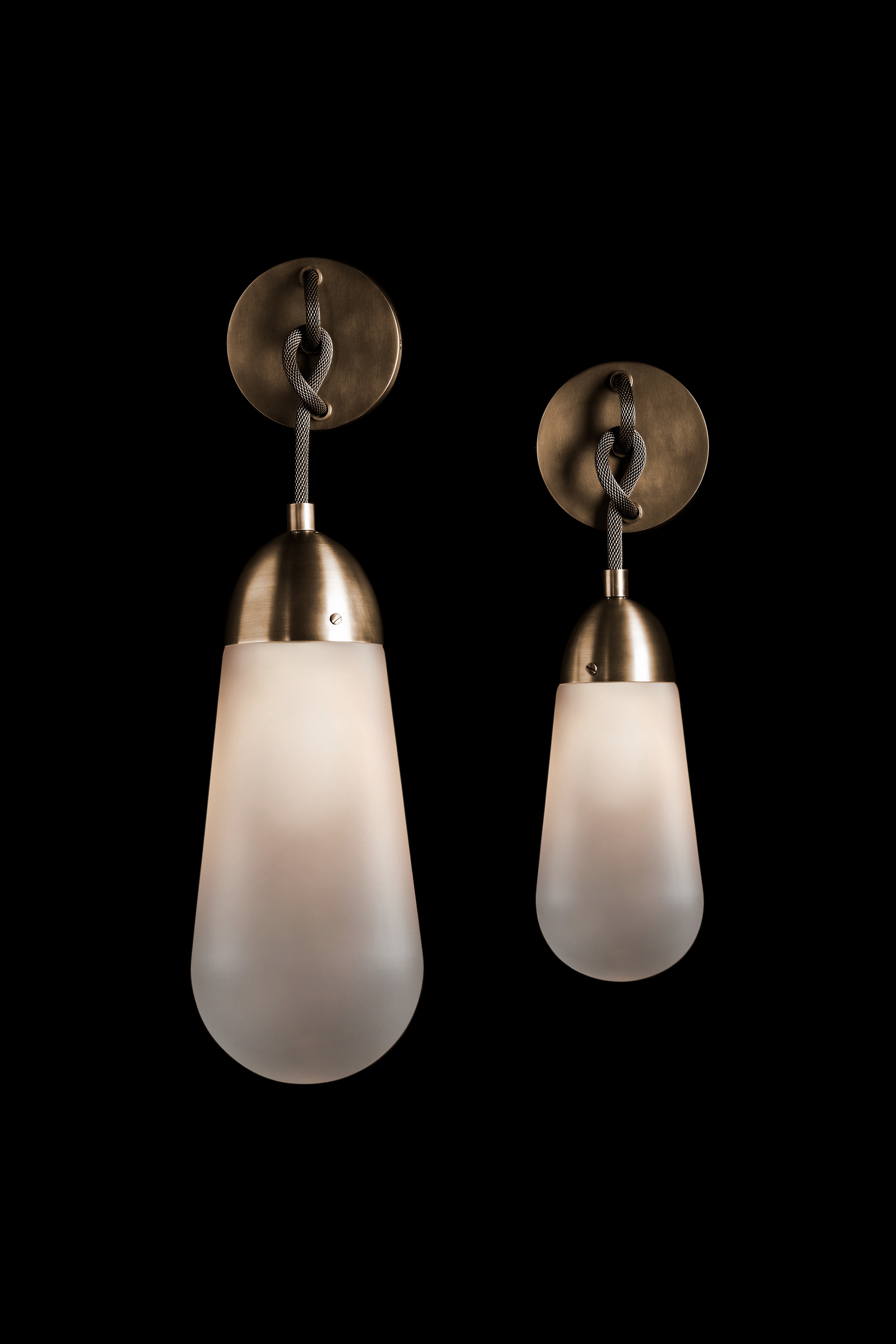 a pair of light fixtures on a black background