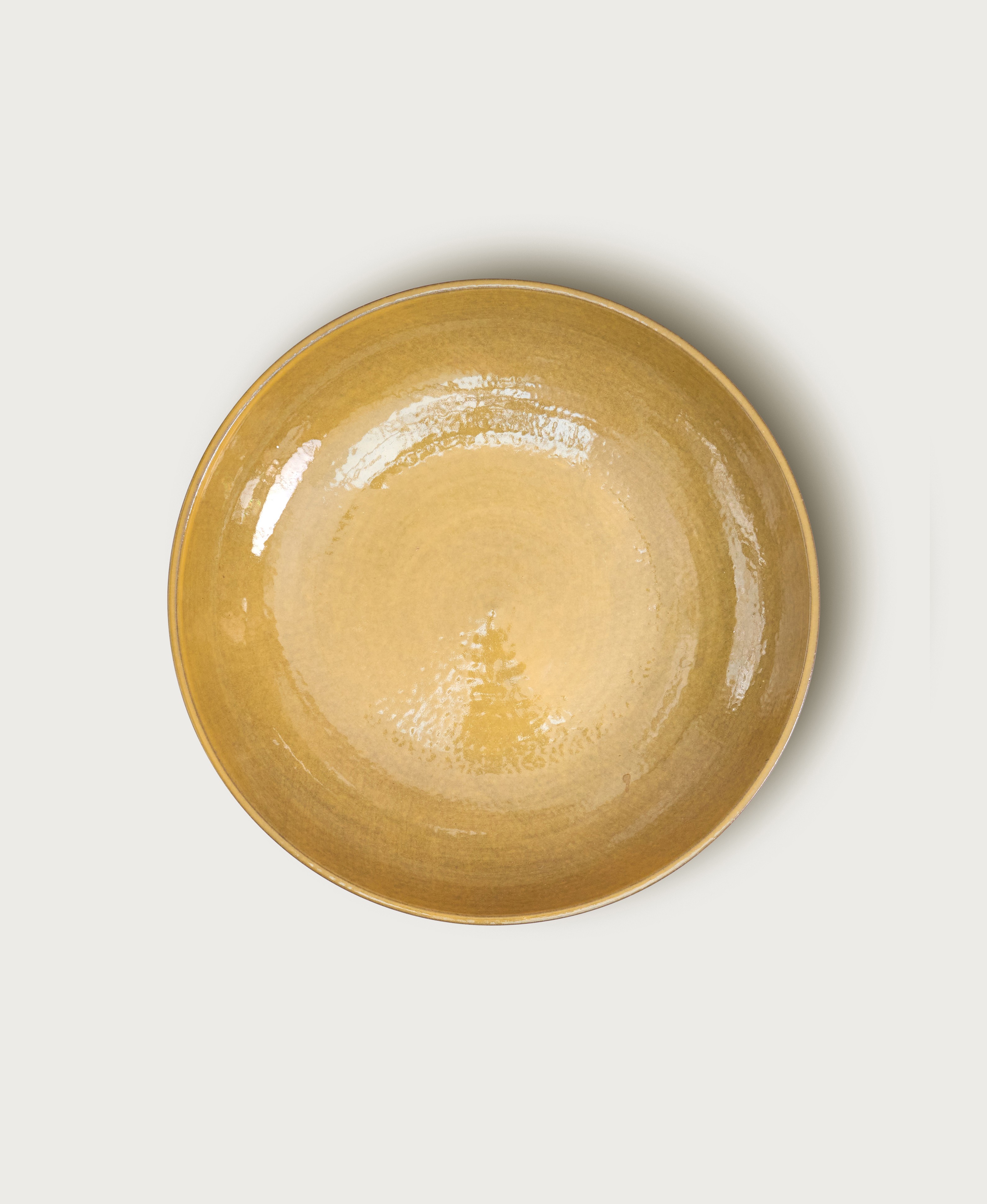 a small yellow bowl on a white surface