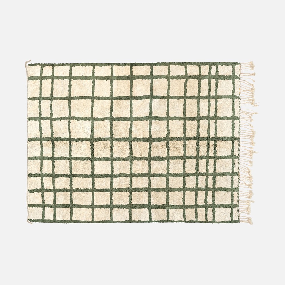 a green and white rug on a white background
