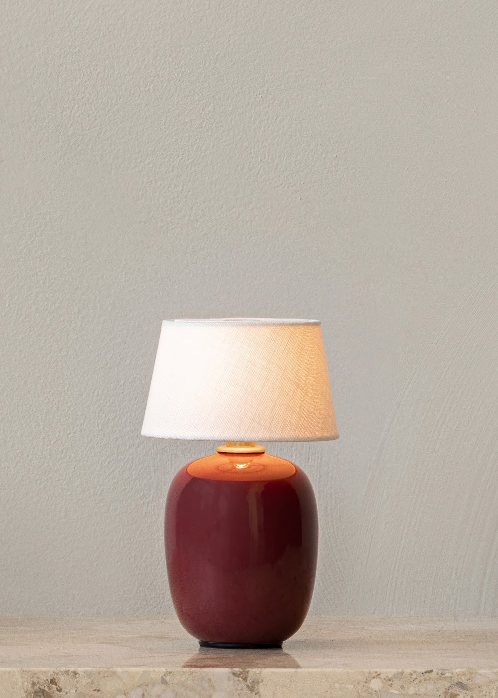 a red lamp sitting on top of a table