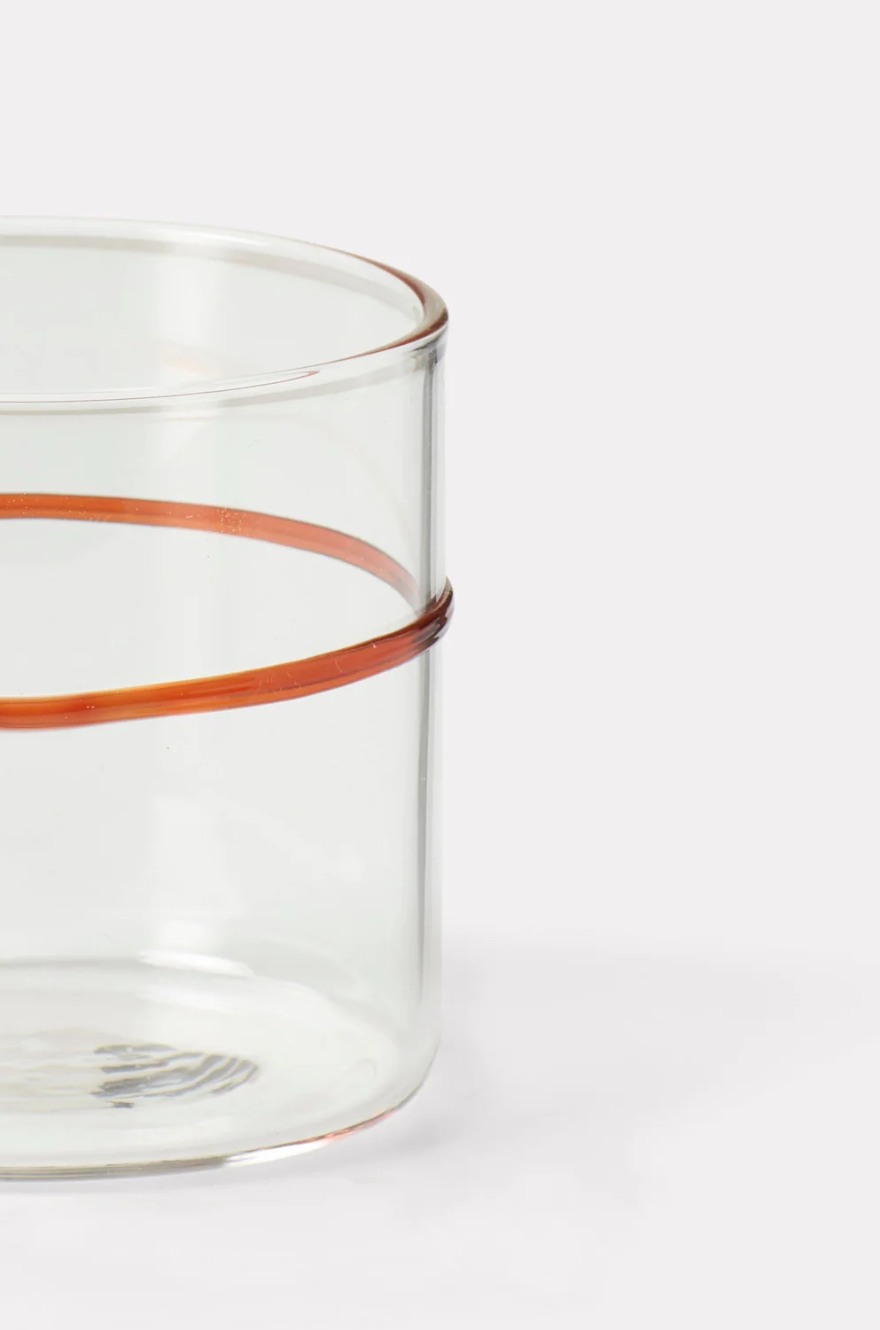 a glass cup with a brown handle on a white background