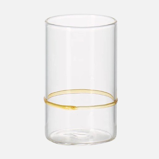 a glass with a gold rim on a white background