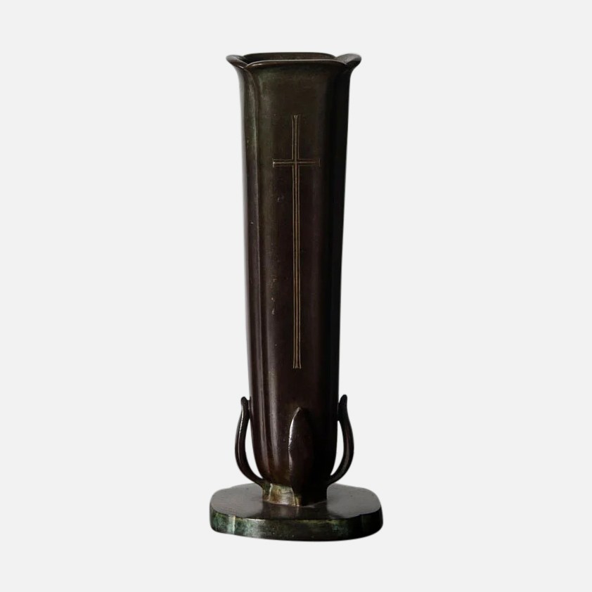 a tall vase sitting on top of a metal stand