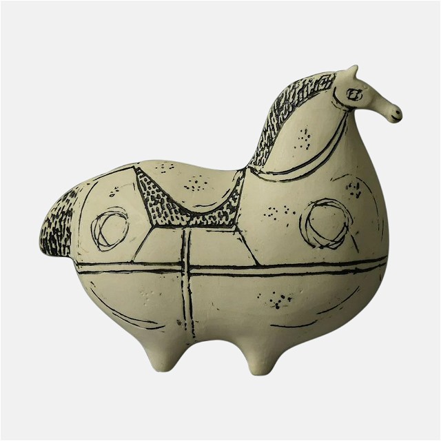 a ceramic horse is shown on a white background