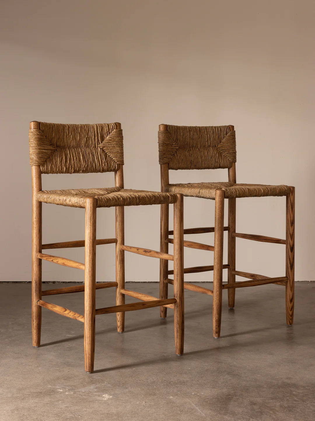 a pair of wooden chairs sitting next to each other
