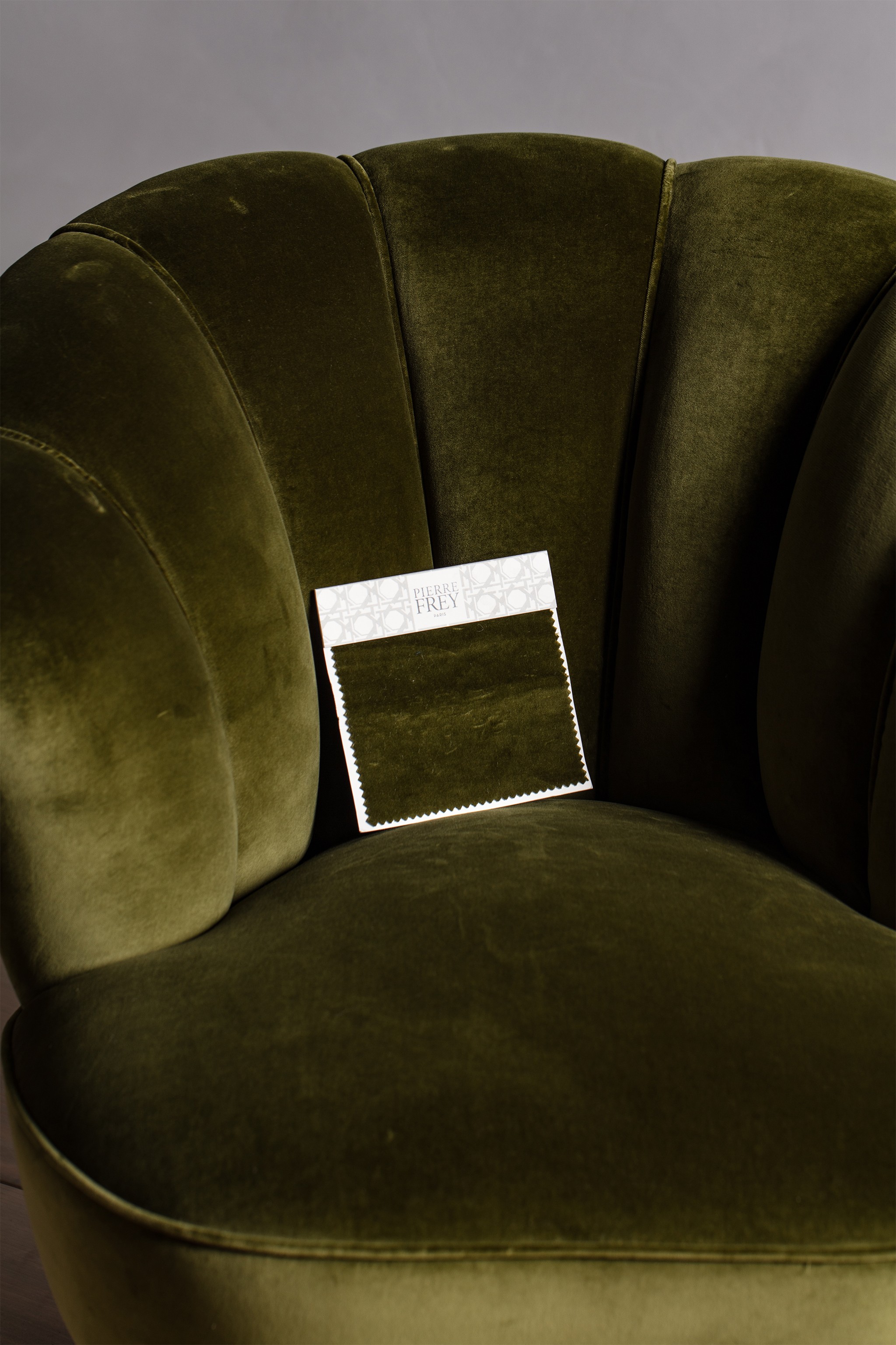 a close up of a green chair with a tag on it