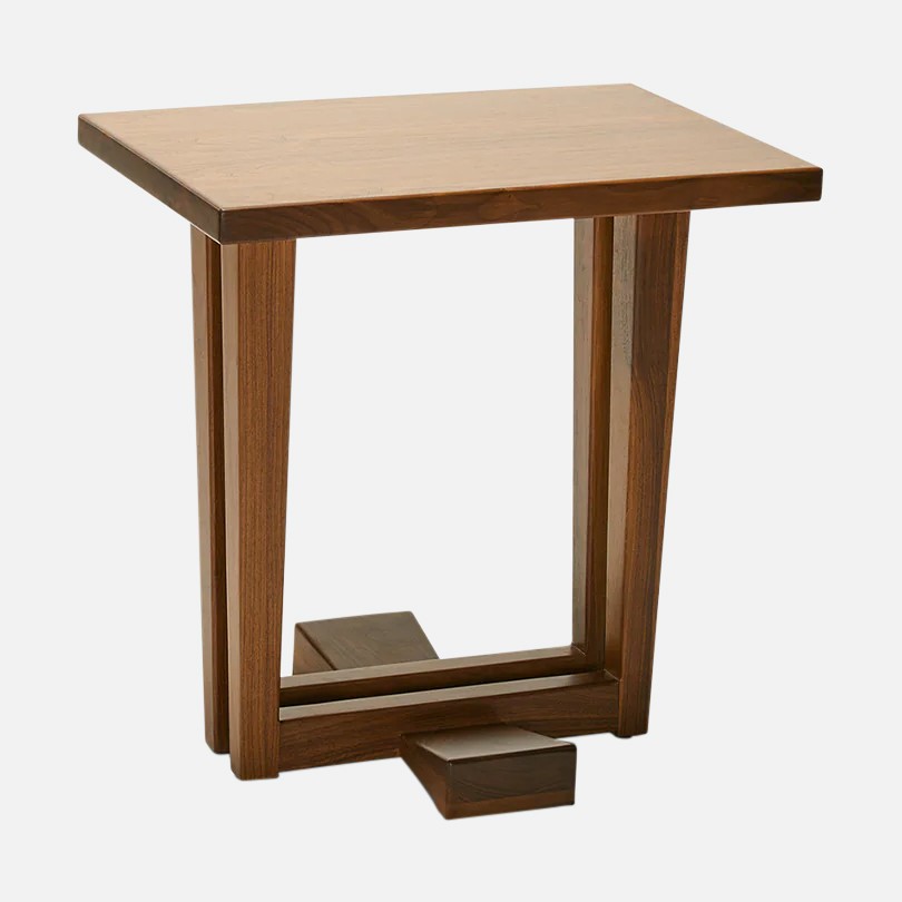 a small wooden table with a square base
