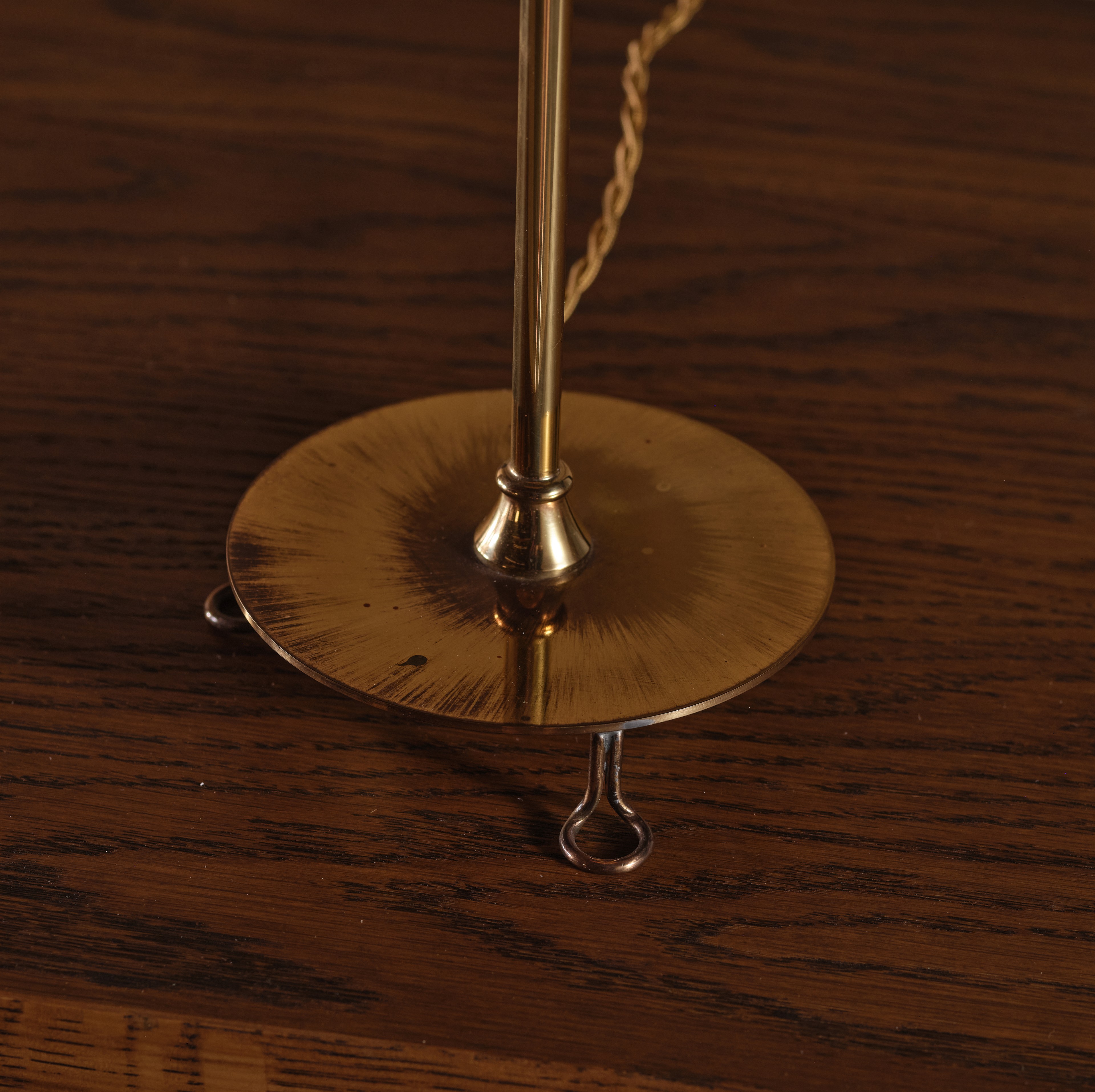 a close up of a clock on a wooden table