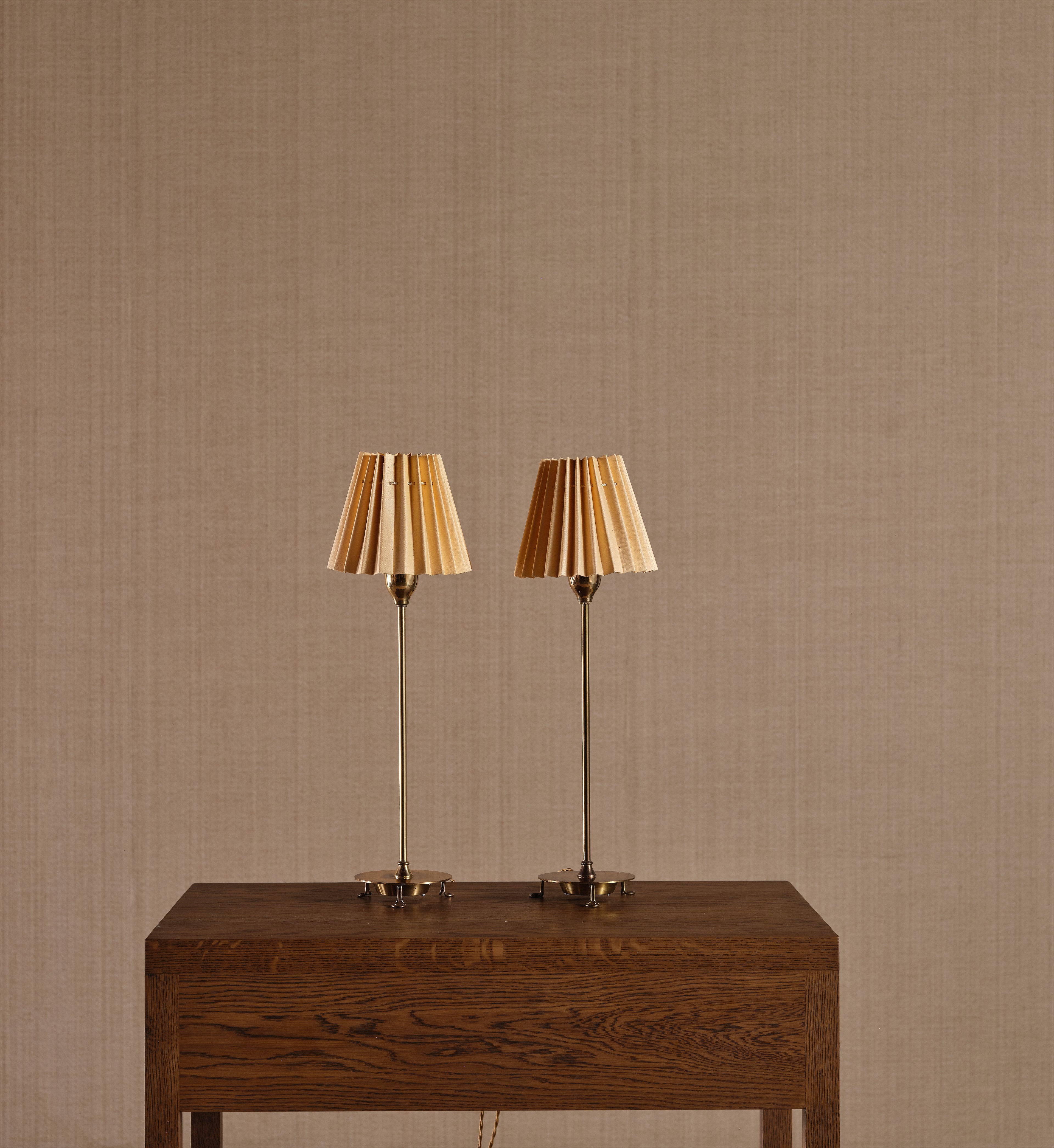 a couple of lamps sitting on top of a wooden table