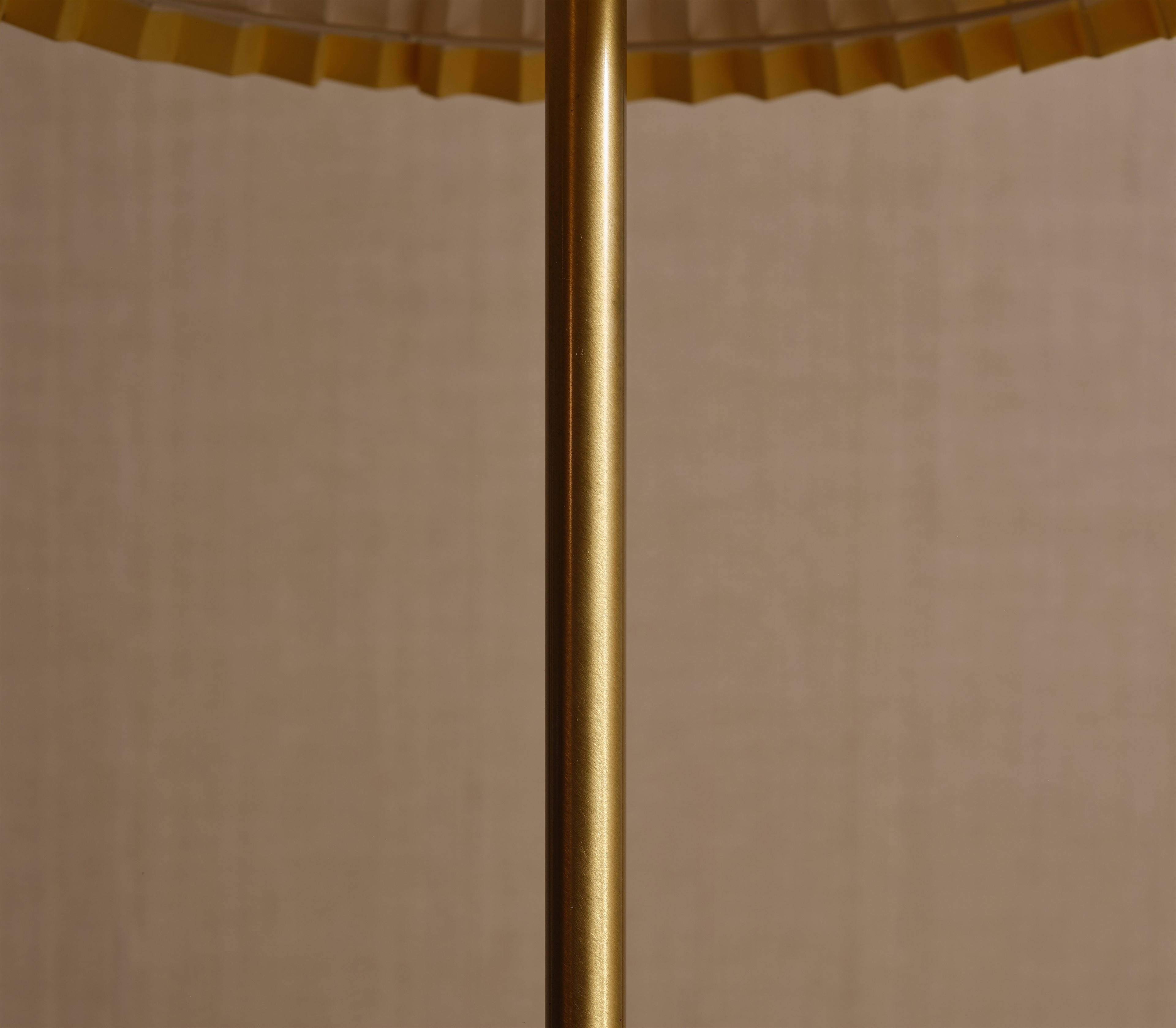a close up of a lamp with a beige background
