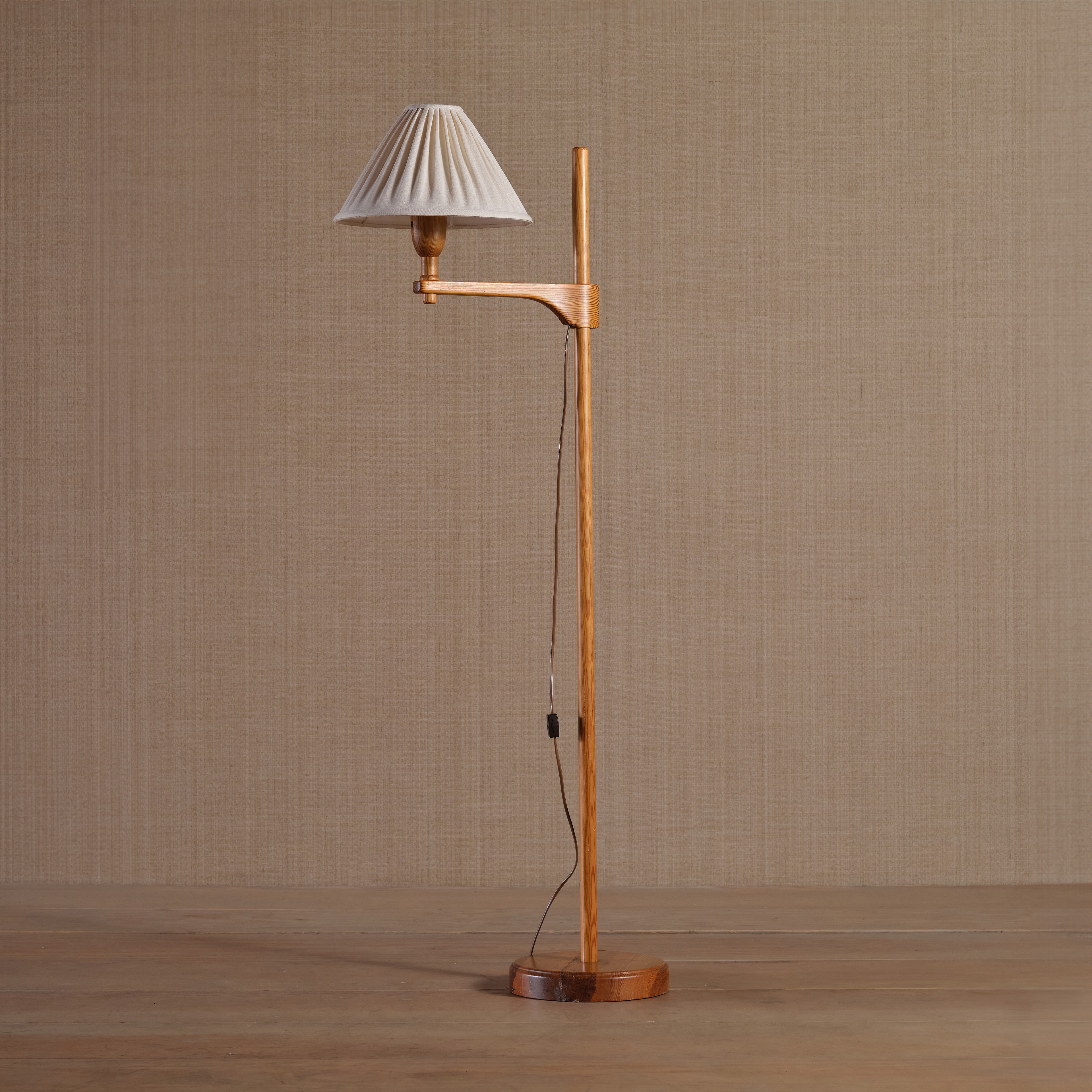 a wooden floor lamp with a white shade