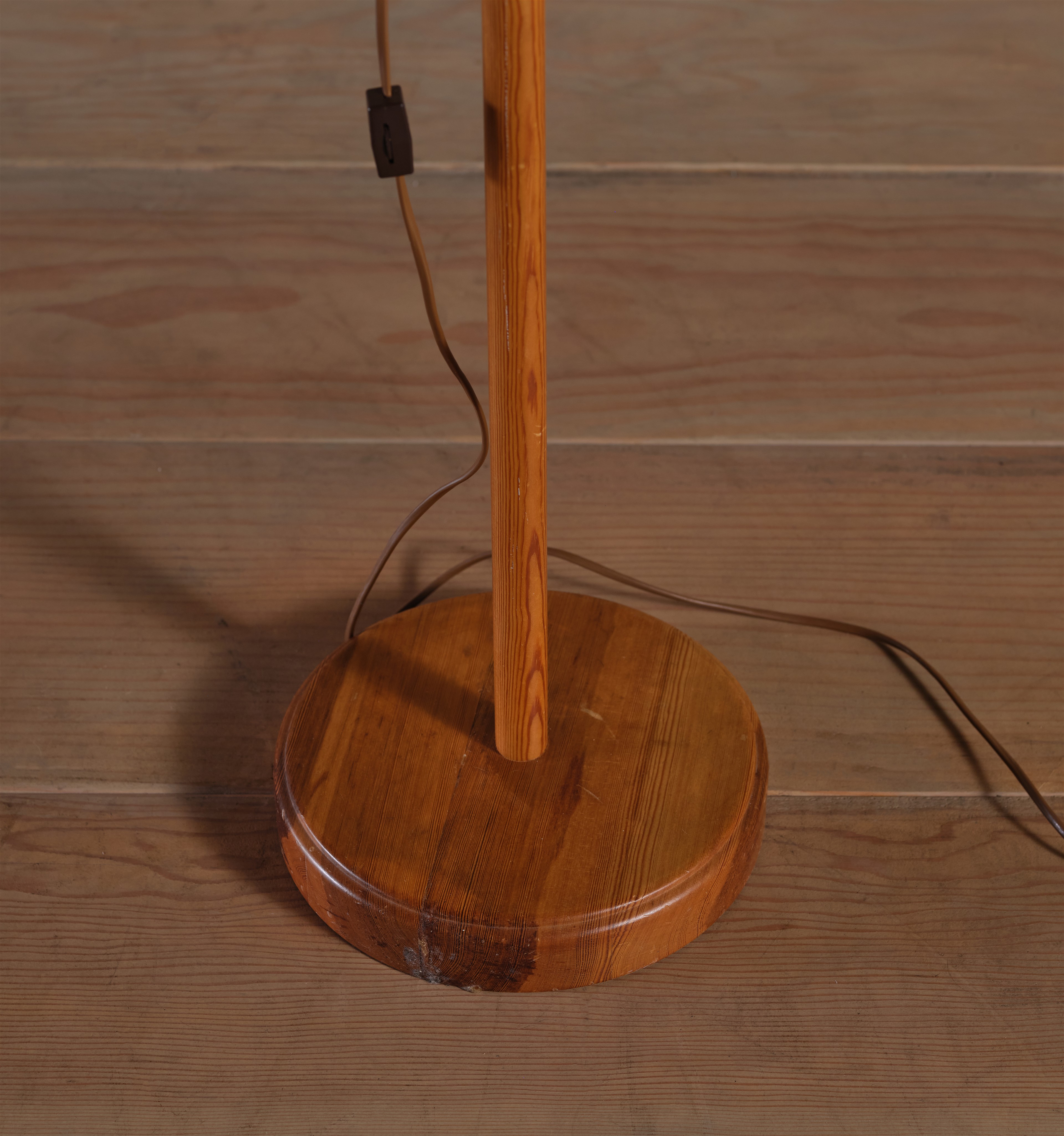 a wooden table lamp on a wooden floor