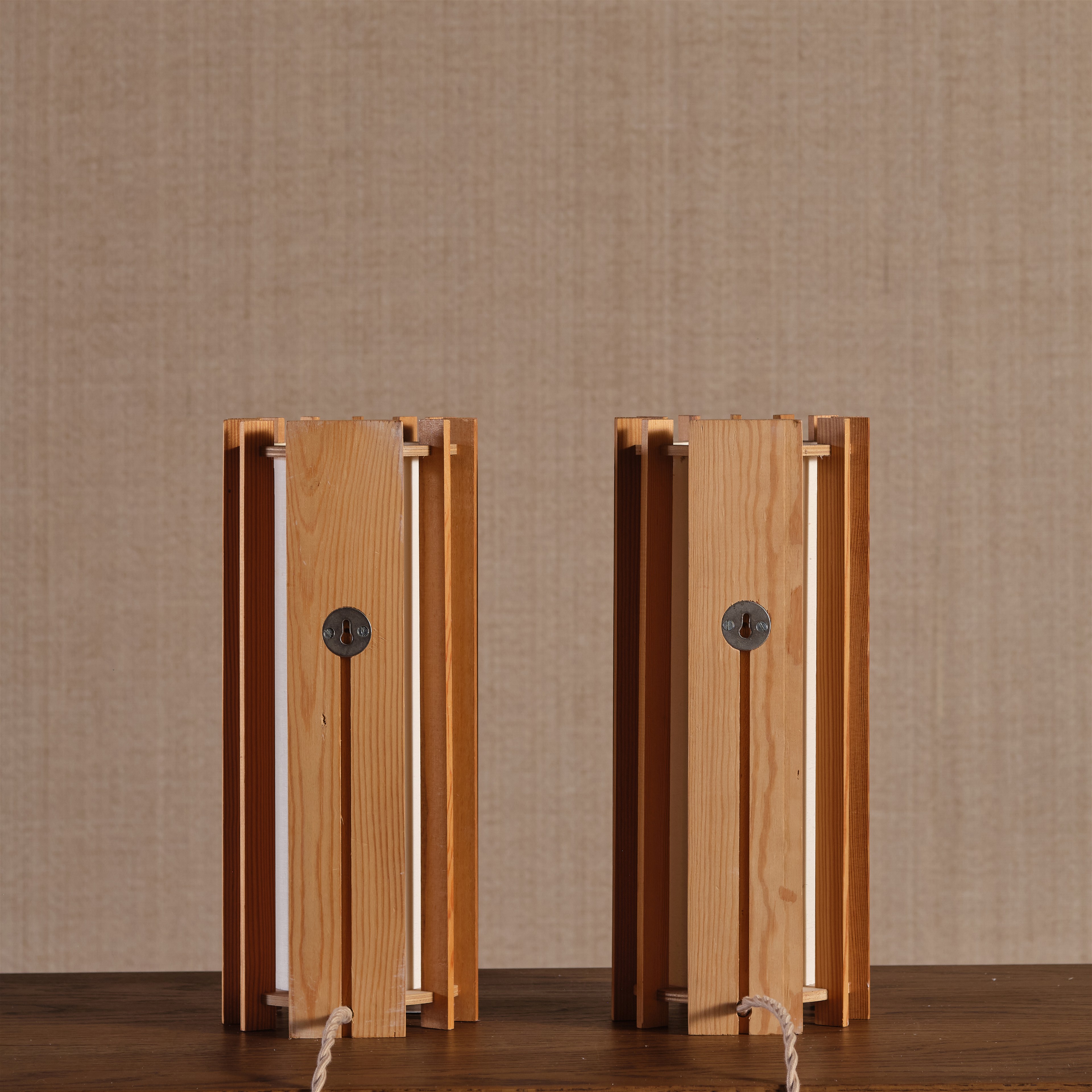 a couple of wooden speakers sitting on top of a wooden table