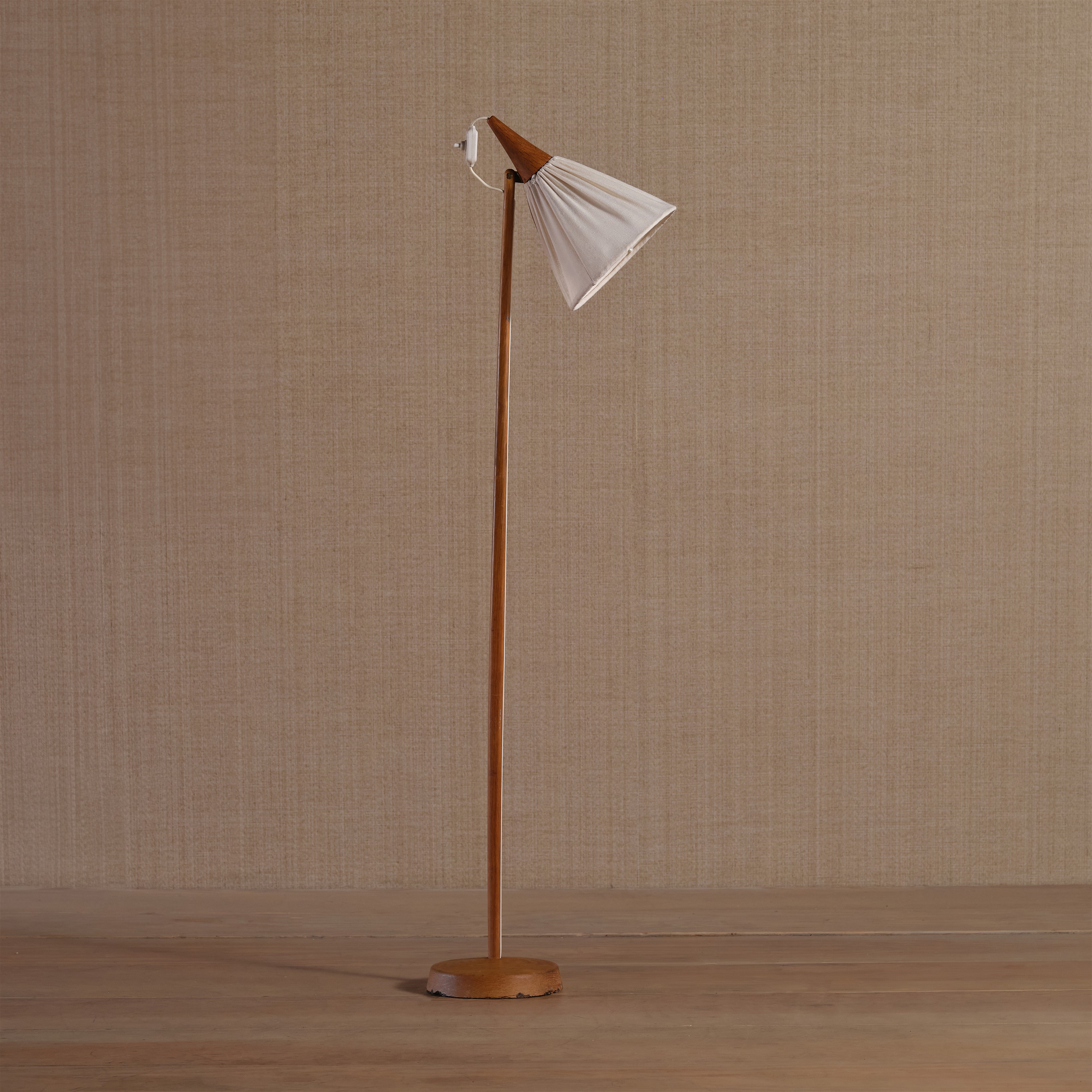 a wooden floor lamp with a white cloth shade