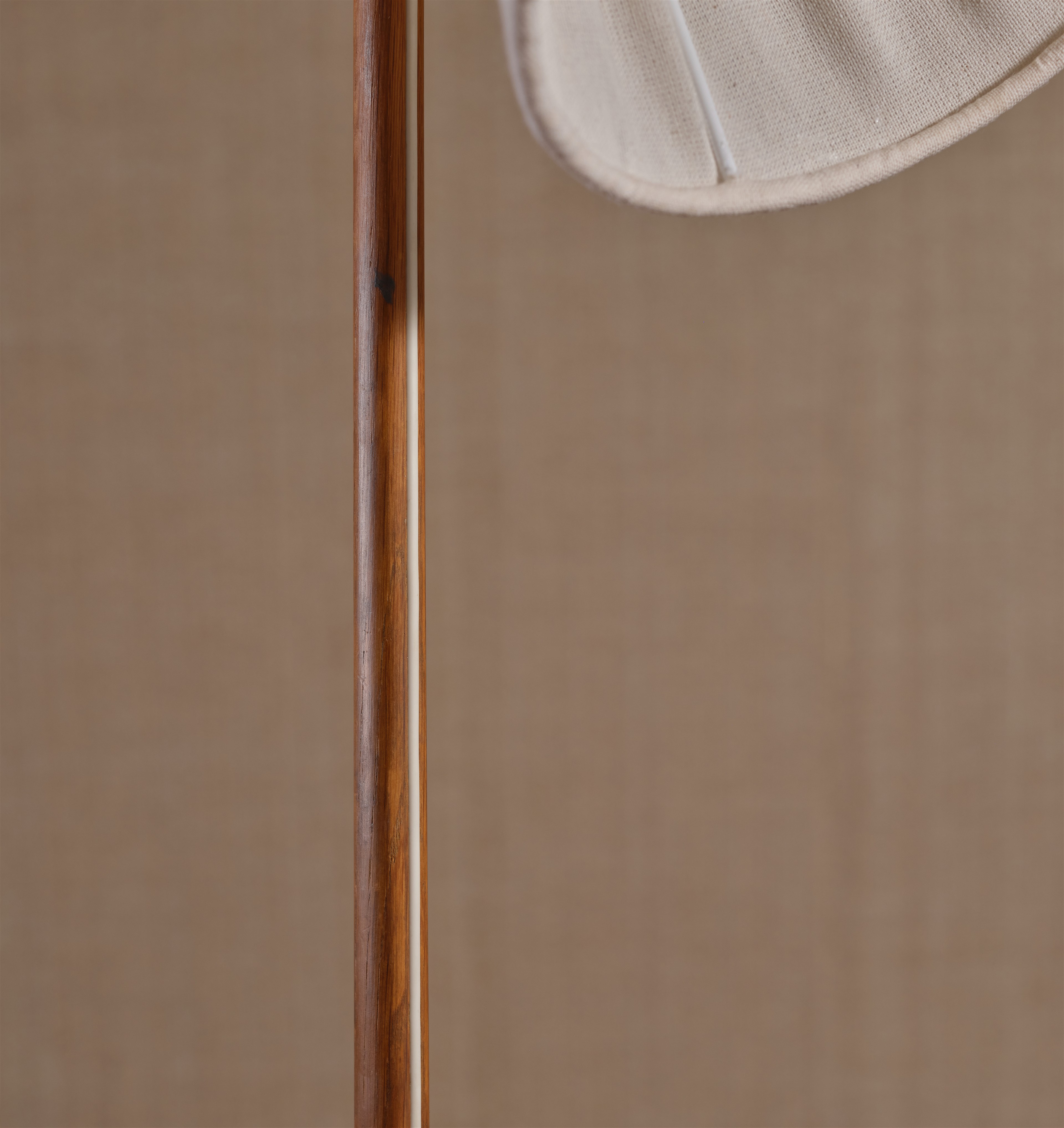 a close up of a wooden pole with a hat on top of it